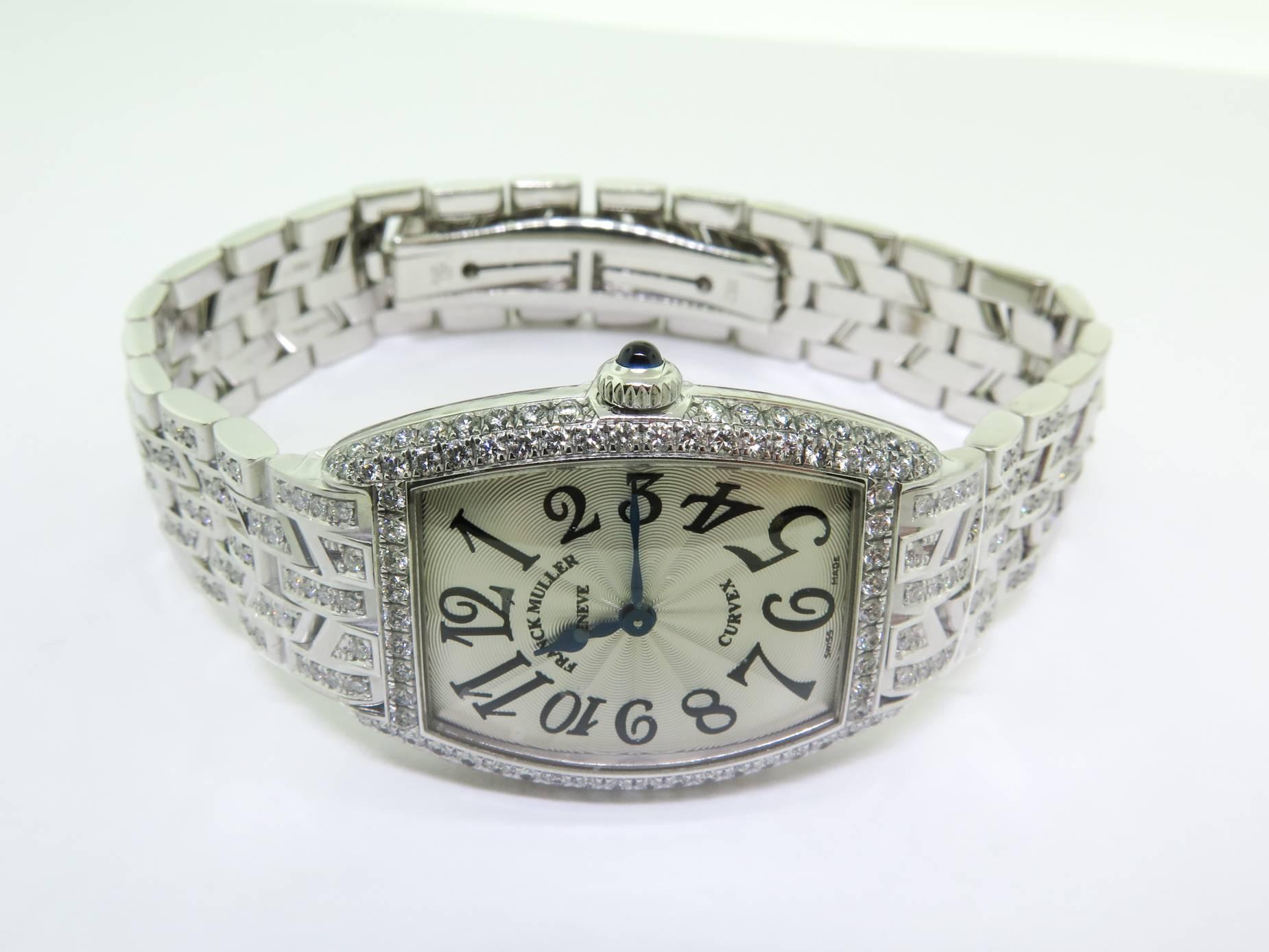 Brand new Franck Muller Cintree Curvex, Model # 1752 QZ D 18k White Gold 25mm x 35mm carefully set with diamonds. Silver dial with Arabic hour markers and blue hands. 18k White Gold bezel set with round cut diamonds. 18k White Gold crown set with
