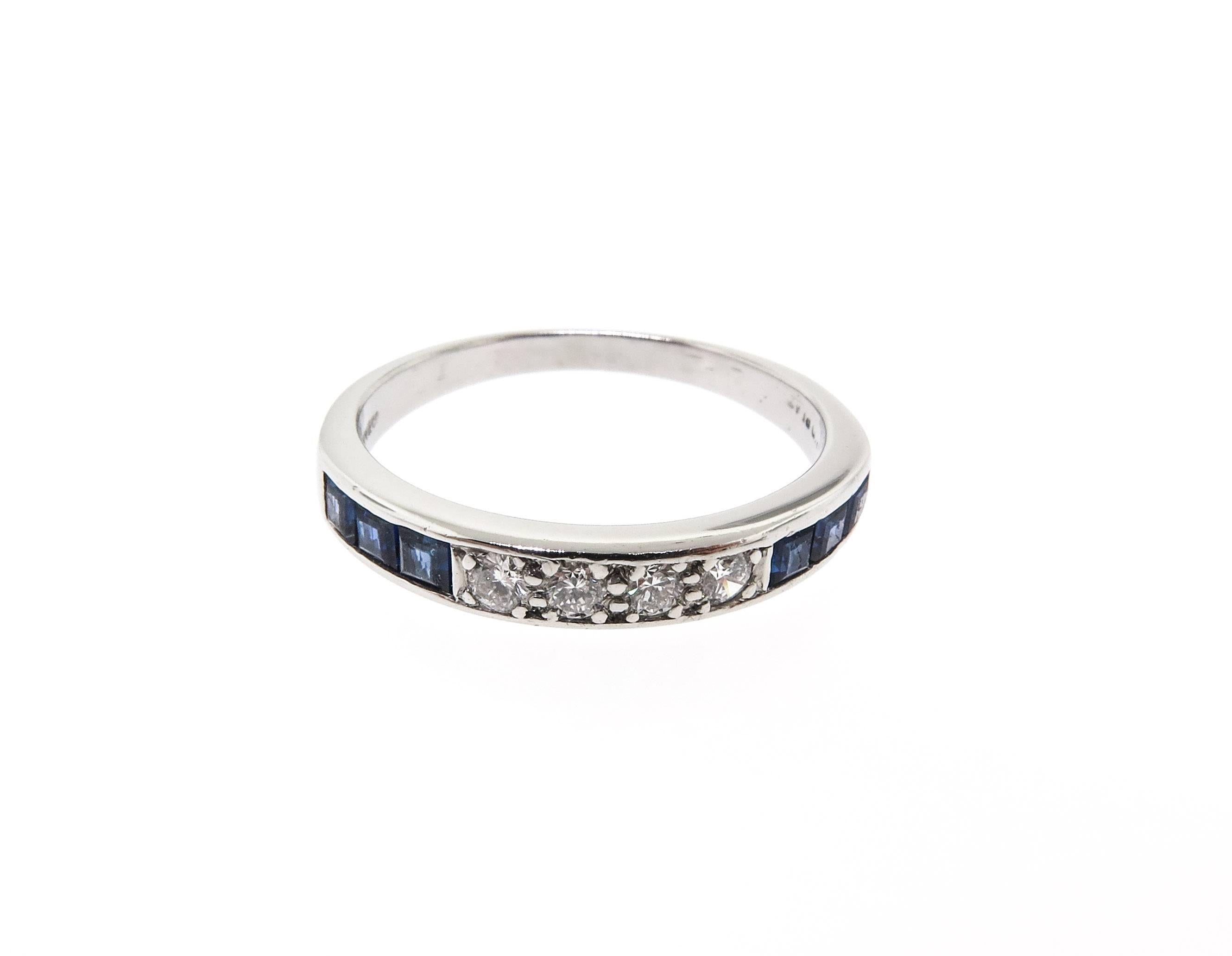 Sapphire and diamond band ring, showcasing 6 square-cut sapphires alternating with round brilliant-cut diamonds at the center of the band, the gemstones are channel-set in high-polished platinum. Diamonds weighing 0.08 total carats and sapphires