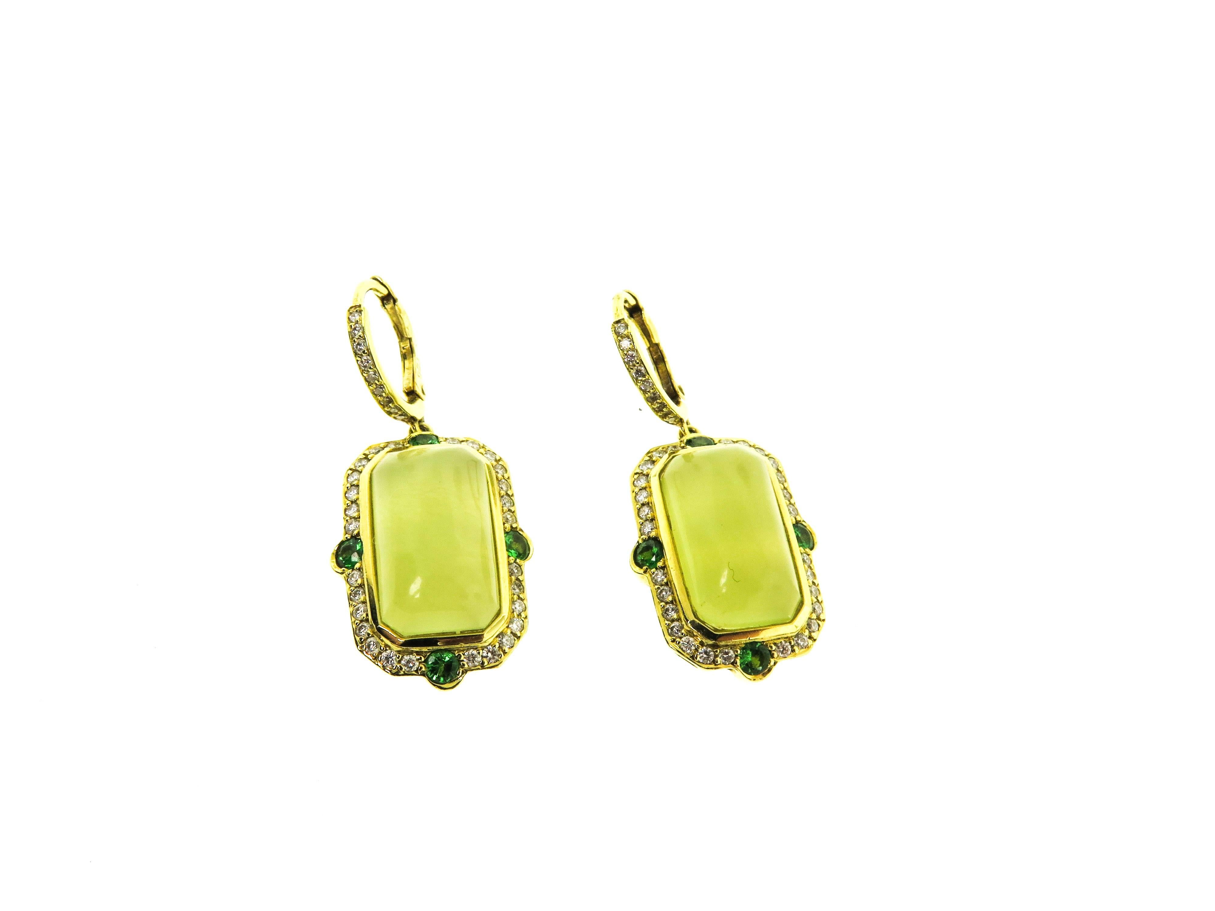 These elegant earrings exhibit a distinctive green hue, the rarest and most valuable color in which to find one of these legendary stones. The cabochon cut  green Beryl is framed by approximately 0.84 carat of micropavé-set diamonds and 0.80 carat