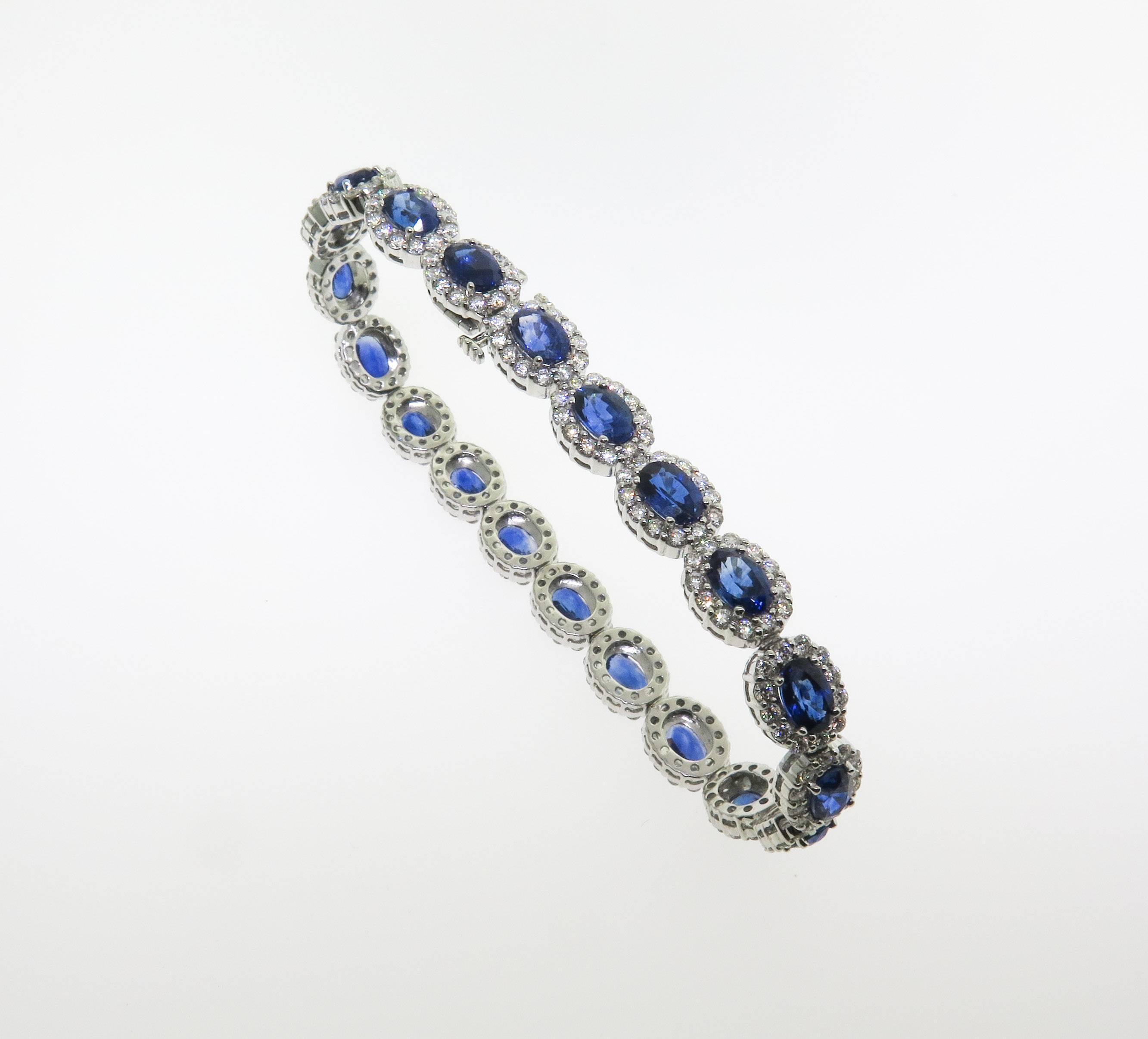 Magnificently matched 20 faceted oval sapphires, prong set in frames. Surrounding the sapphires are halo's of brilliant cut white diamonds having a total weight of 4.17 carats. Combining blue sapphires with diamonds always results in a stunning
