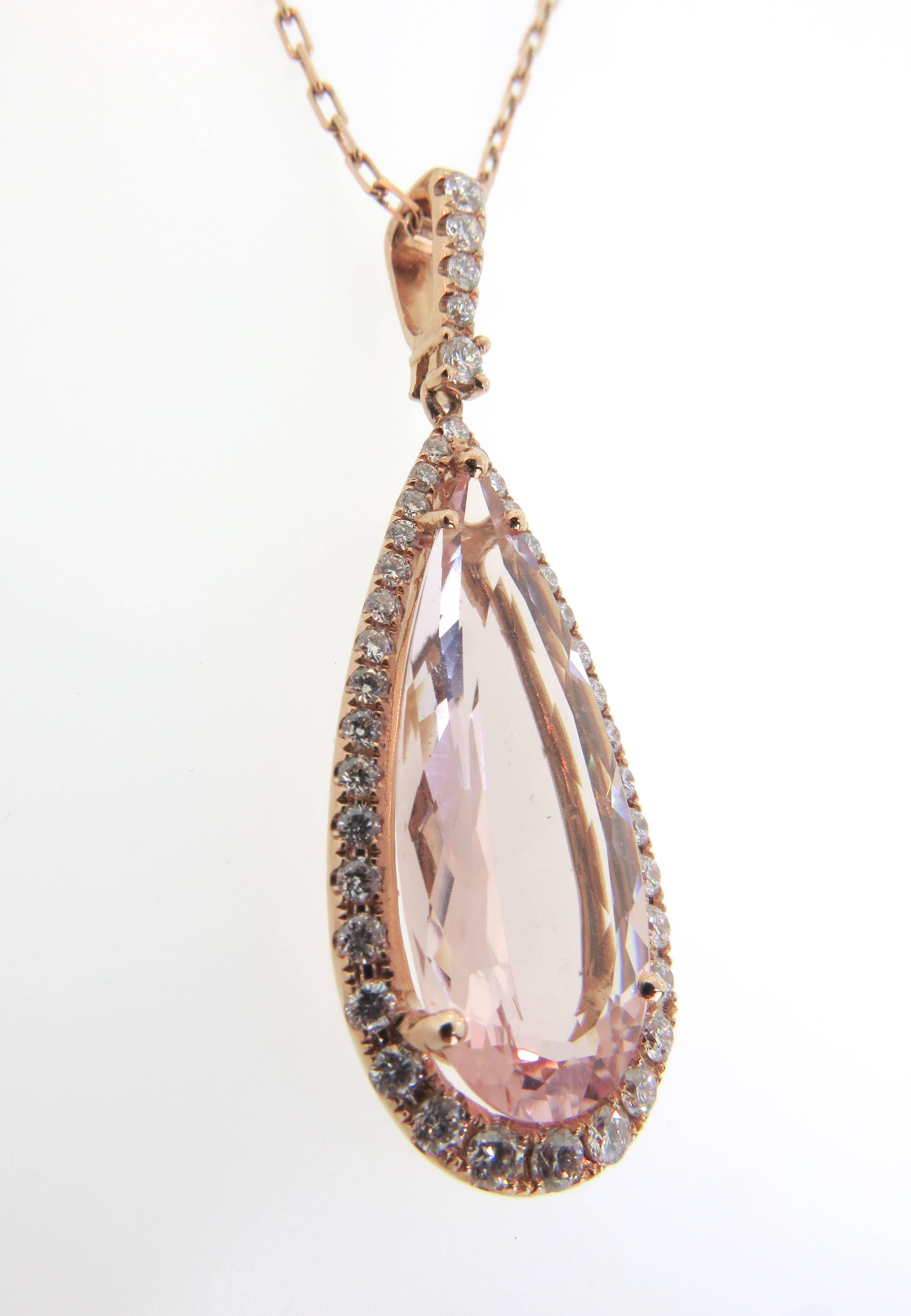 Gorgeous 8.72 carat elongated pear shaped Pink morganite surrounded by 41 dazzling white diamonds in this refreshingly beautiful pendant, suspended by an 18K rose gold chain 24 inches long. 

