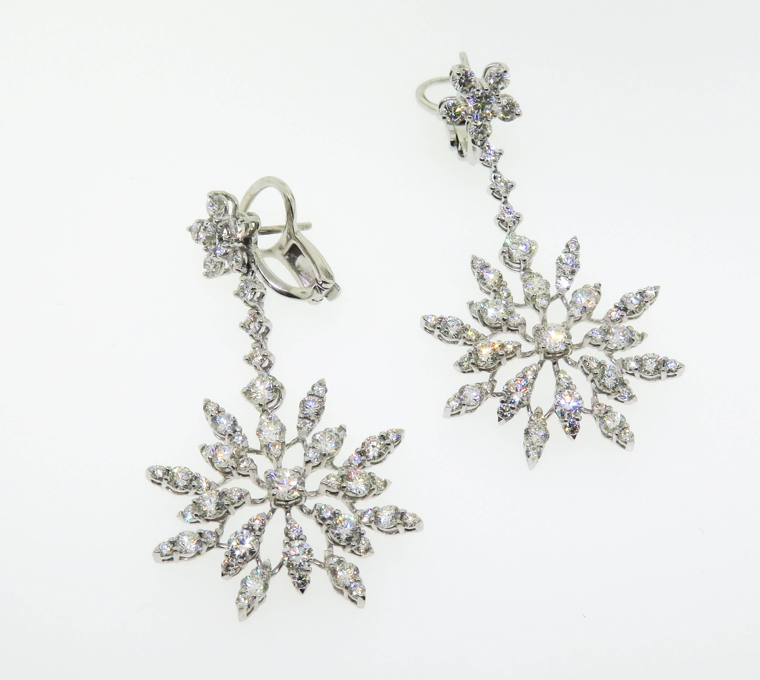 Swinging ultra-sparklers!
This beautiful pair of 18k white gold diamond earrings, centered with two stunning round shape diamonds. This look effortlessly dresses up for cocktails or a formal event.  Accentuating it with 5.78 carats of G color, VS
