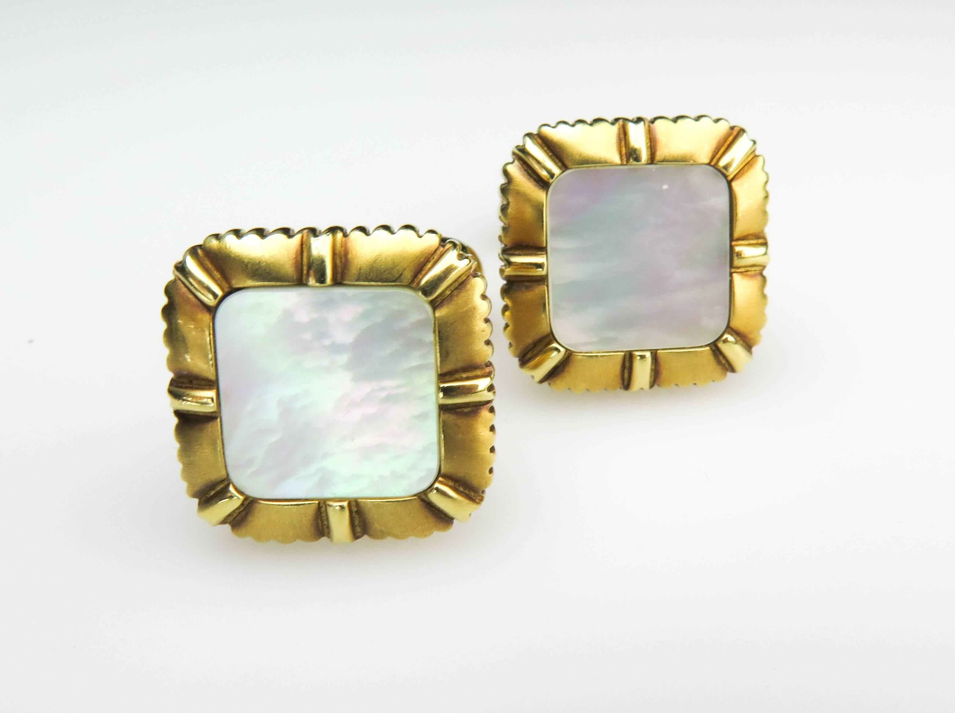 Very polished and handsome 18k yellow gold cufflinks. Inlaid luminous mother-of-pearl on both front and back sides. Made and signed by Asprey & Garrard.  The back swivels for easy closure. A bright beautiful cufflink.