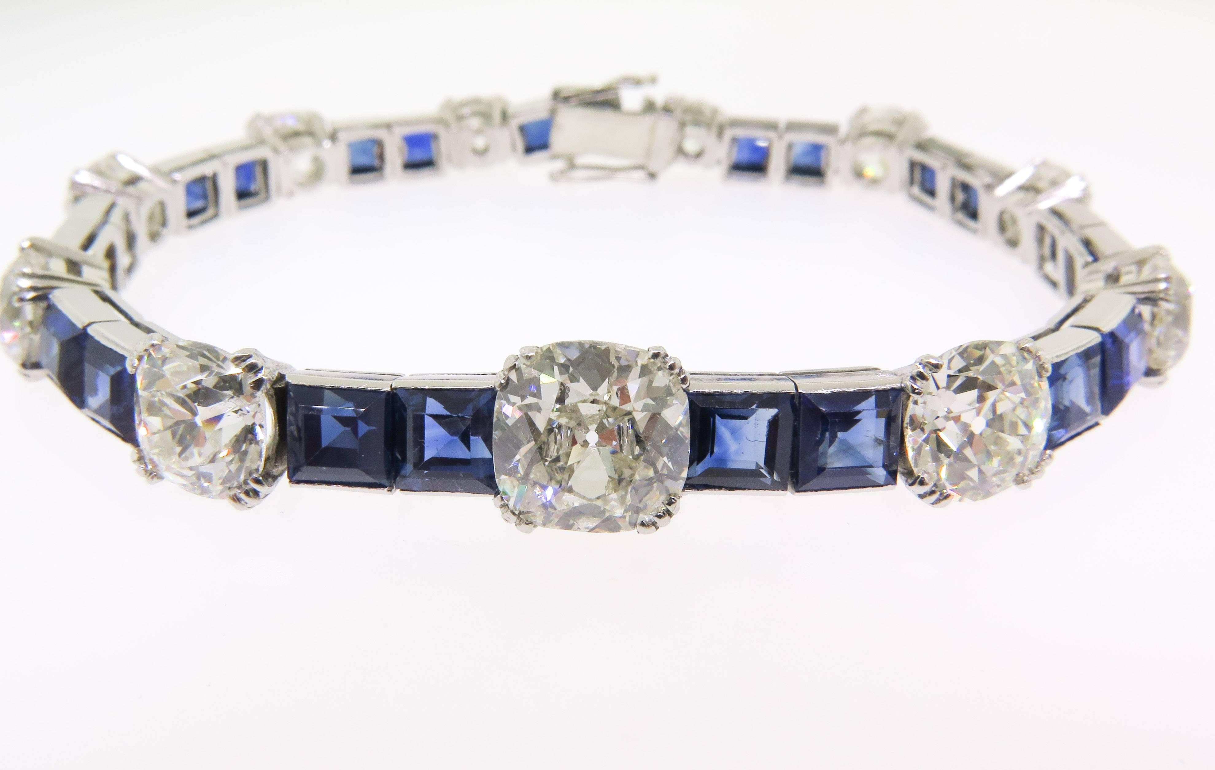 This beautiful bracelet has flare. There are 11 old mine cut cushion shaped diamonds with 22 princess cut sapphires. This is a meticulously crafted bracelet. Sapphires are of great quality and color with a total weight of 12.00 carats and 17.03