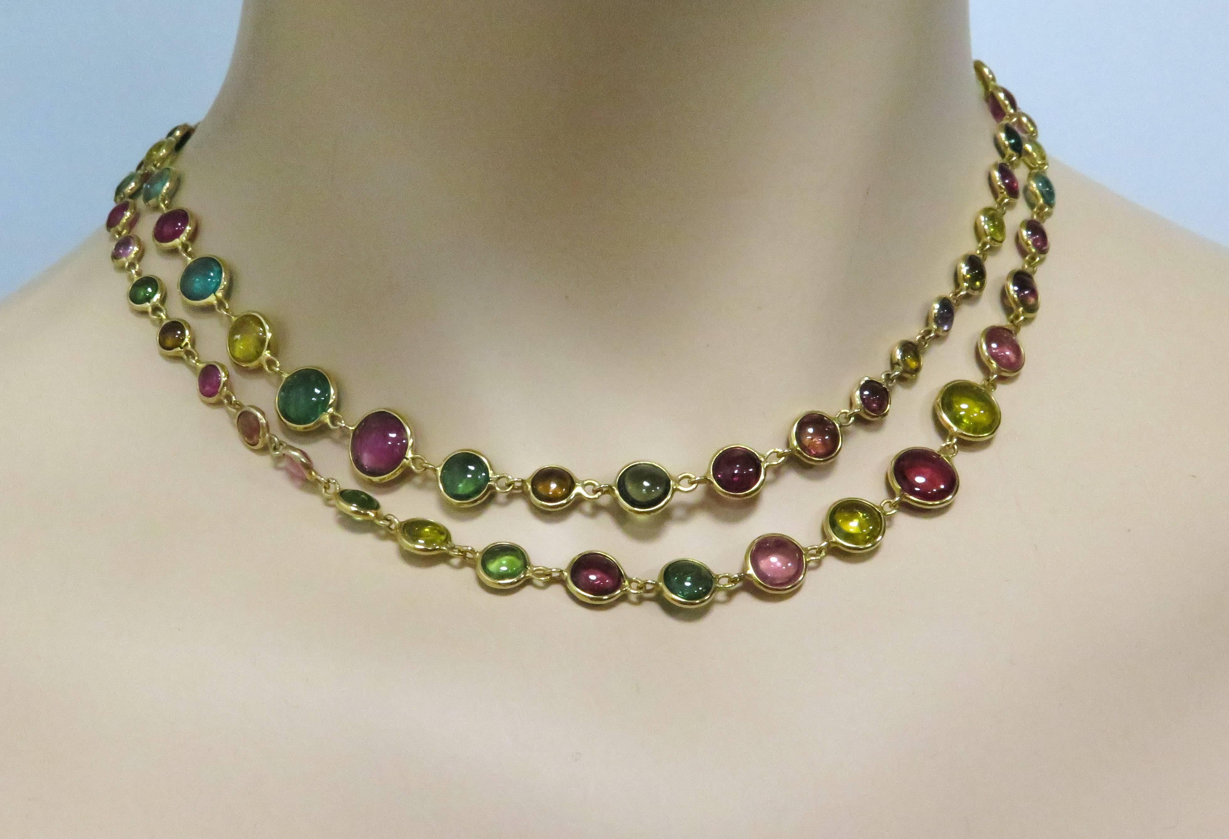This gorgeous multi-colored tourmaline necklace is designed by Peggy Daven.
The Tourmaline beads range from approximately 5.5mm to 8.5mm in diameter each, in a flattened cabochon shape individually set in a 18k yellow gold bezel. 30 inches long