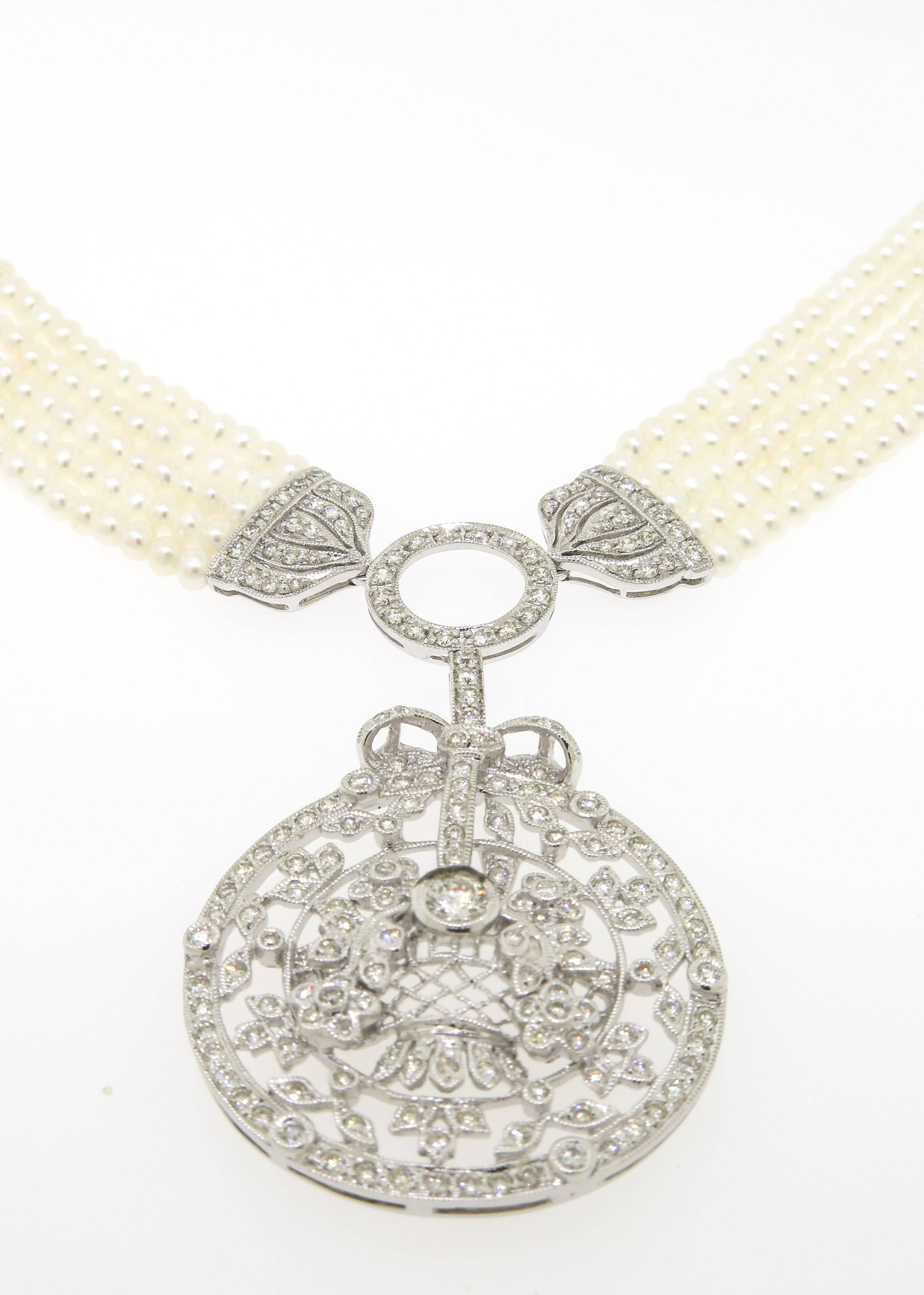 Gorgeous freshwater pearl necklace with diamond filigree enhancer style pendant. Strung within five strands of 2.5mm pearl and diamond filigree circle details in 18k white gold. Clasped with pave diamond bars and chain extension closures that can be