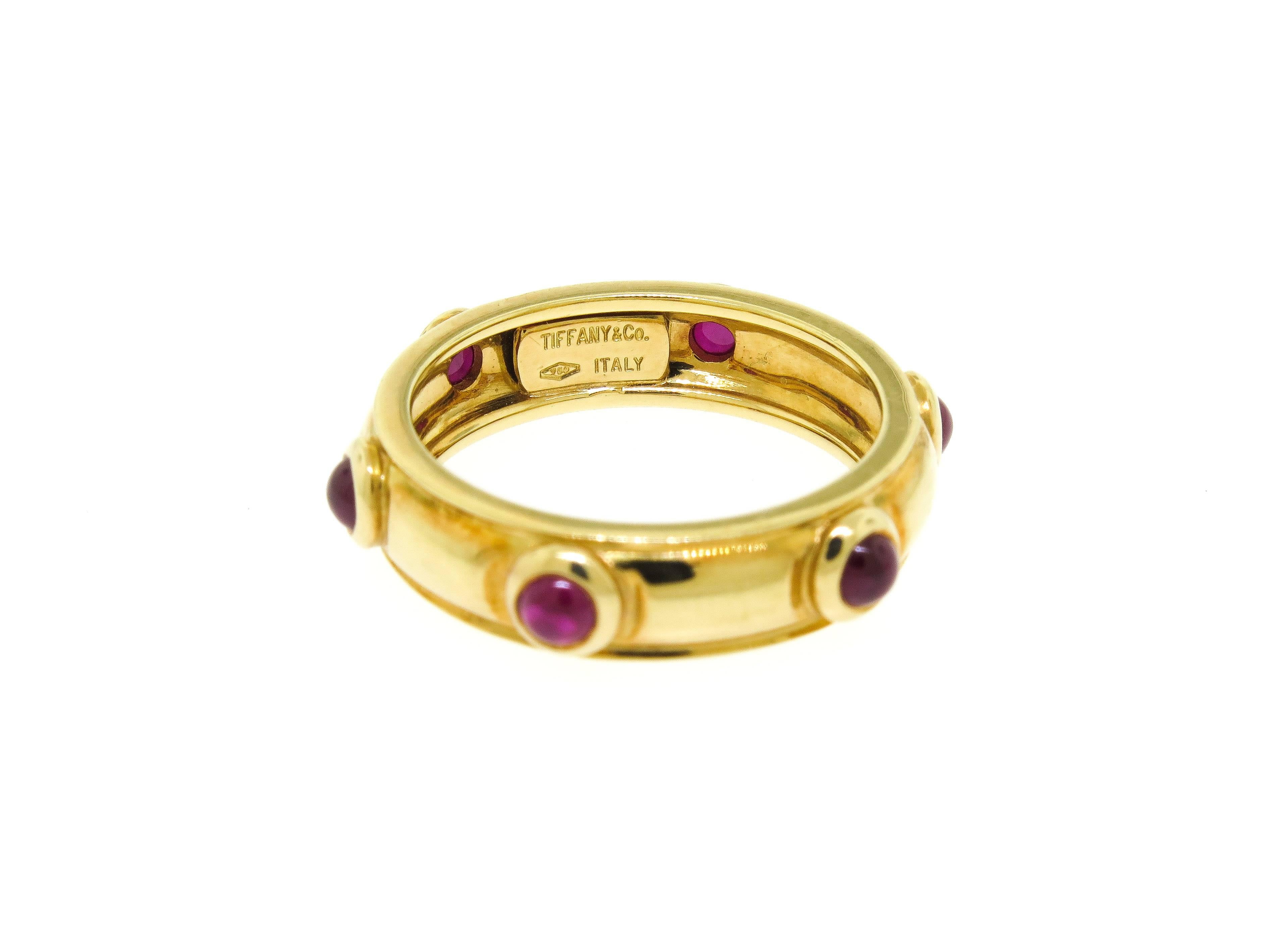 Chic ring created by Tiffany & Co. Made of 18k yellow gold and set with 6 cabochon rubies. The ring is size 7.25. It is stamped with Tiffany & Co. maker's  hallmark. Beautiful and wearable as a stackable, or to enjoy on its own. 