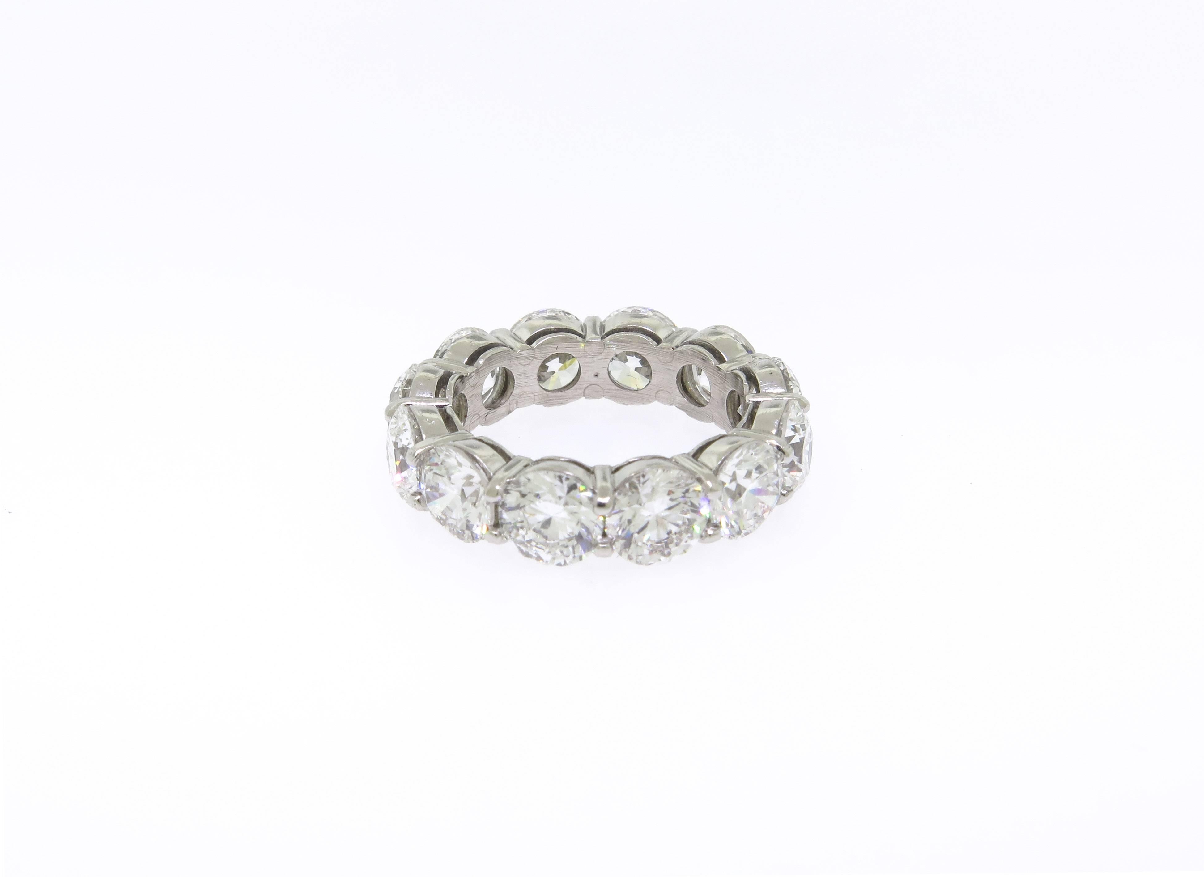 This platinum eternity wedding band features 12 prong set round brilliant cut diamonds. The diamonds are F color, SI1 clarity and a total weight of 8.52 carats. Size 5.5 GIA certified.