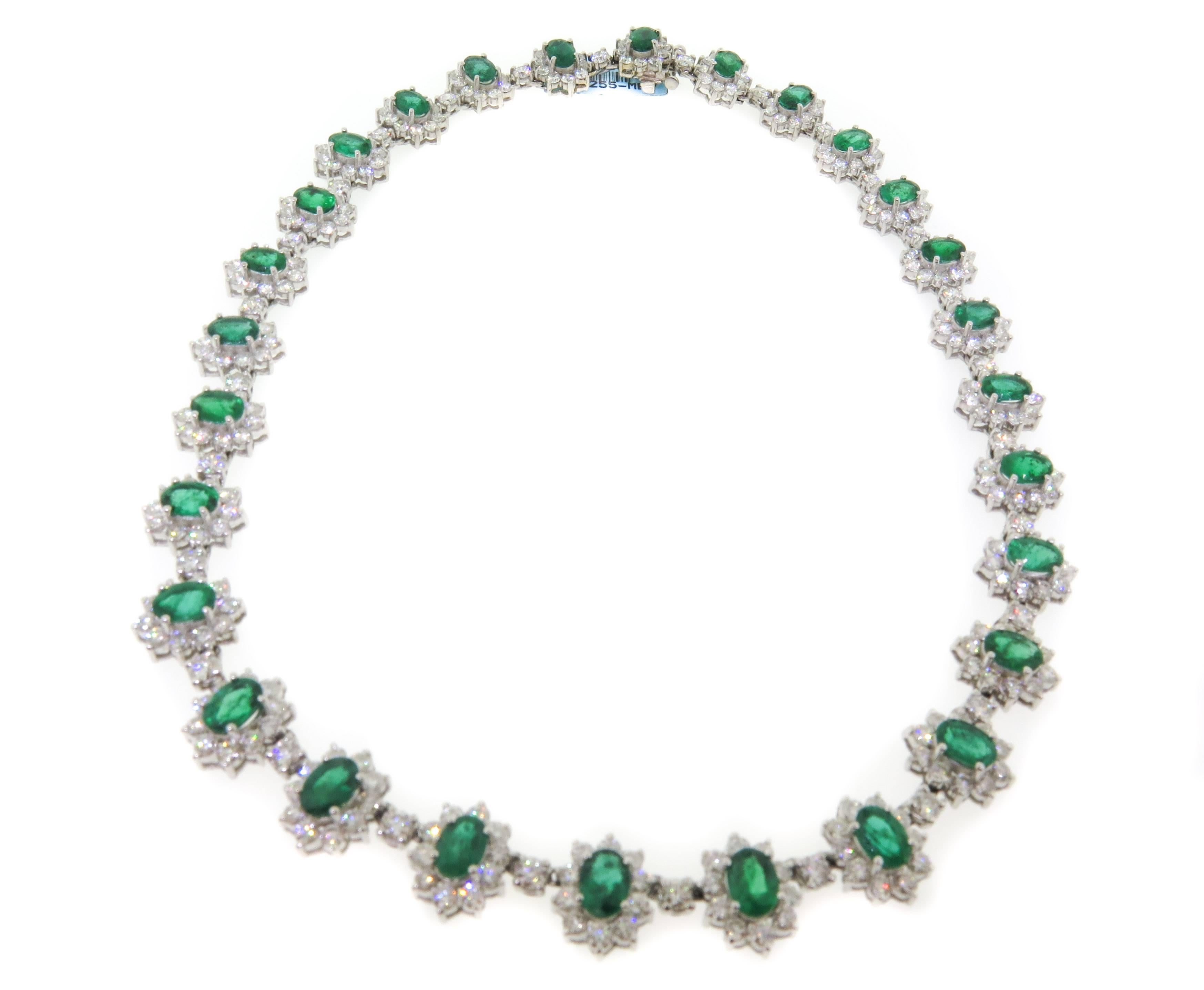 A simply stunning emerald and diamond necklace. This magnificent treasure, handcrafted in white gold and features 28 bright green oval shape emeralds which total approximately 20.47 carats, and round cut diamonds totaling 20.74 carats. A truly