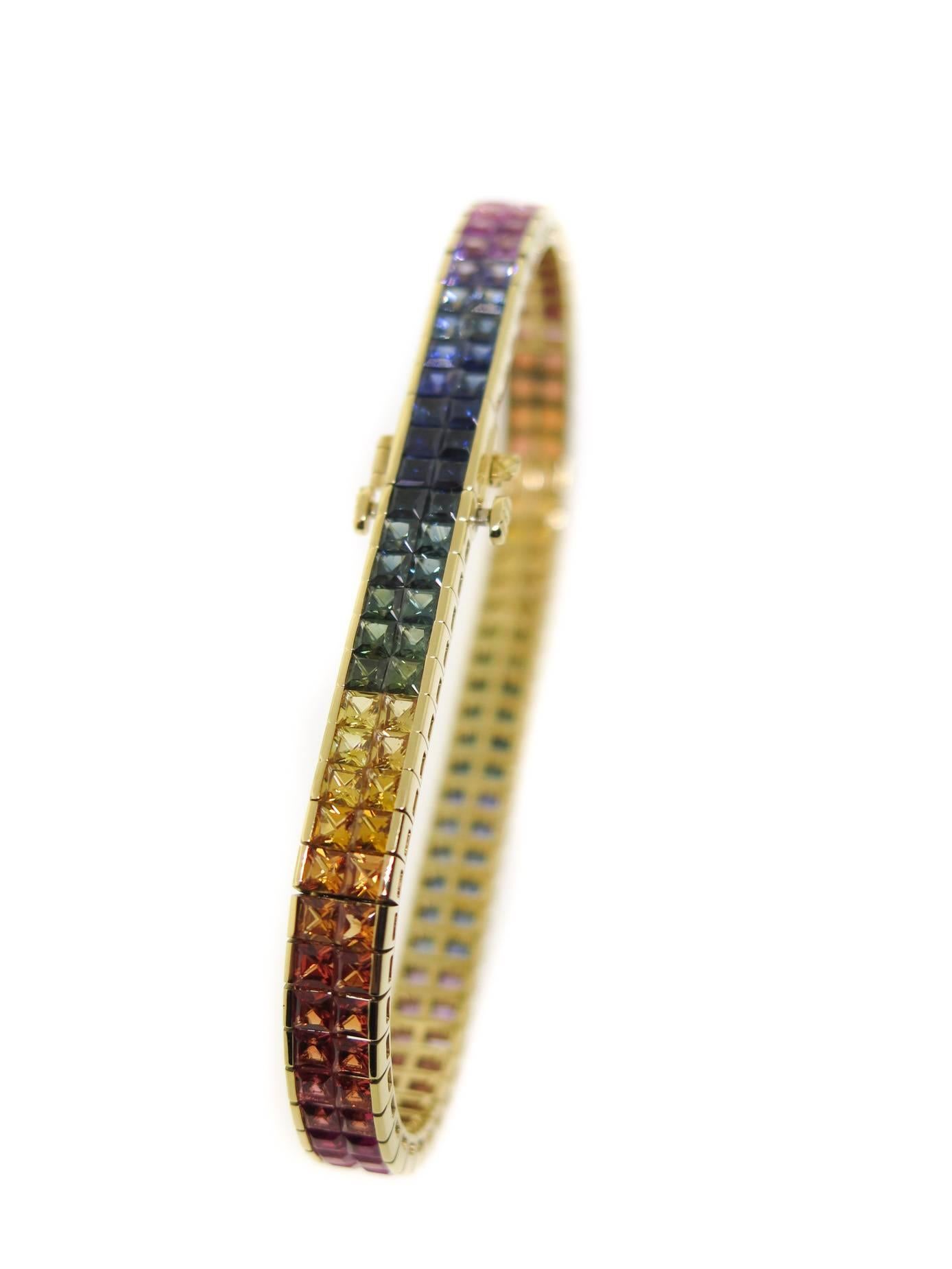 Stunning and beautiful! This rainbow sapphire bracelet features a double row of perfectly matched selection of vibrant colors of sapphires: blue, green, pink, yellow, orange and all the colors in between. Designed and hand crafted in 18K yellow gold