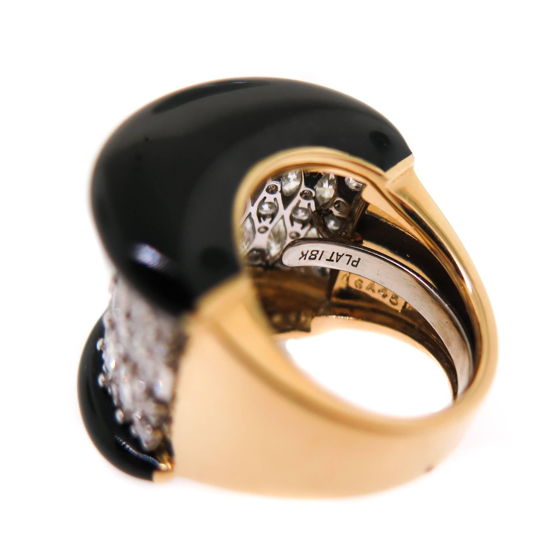 Big, bold and beautiful, this striking David Webb ring is crafted in 18k yellow gold and platinum featuring 4.19 carats of Marquise cut diamond and 1.43 carats of round brilliant cut diamonds, beautifully design and accented with black enamel sides.