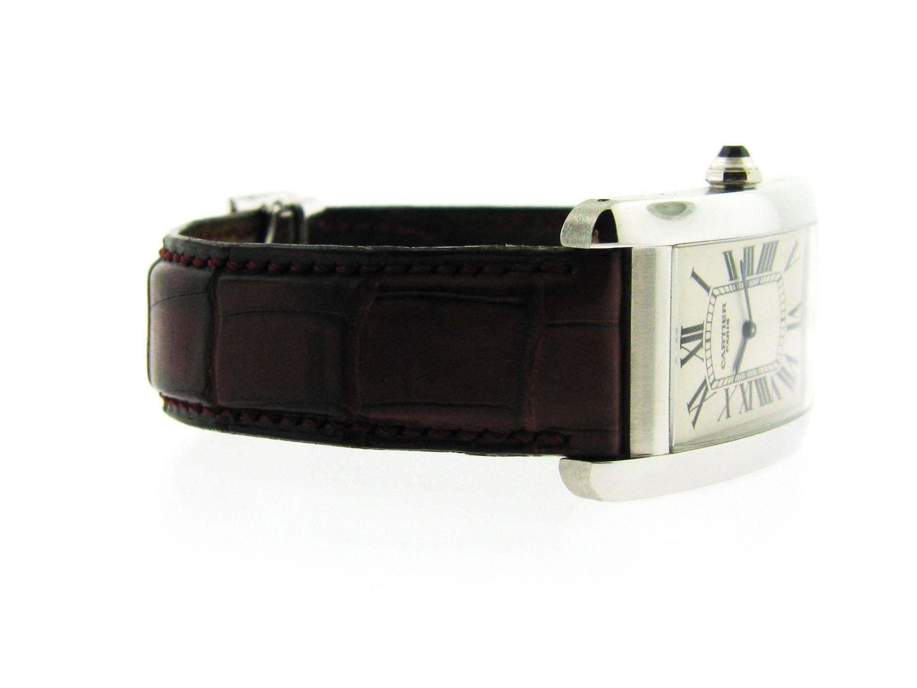 Cartier Tank American, large model Ref. W2604351.  Platinum case measuring approximately 45 x 26 mm, manual wind  movement, natural blue spinel gemstone set in the crown, scratch resistant sapphire crystal and 18-karat white gold deployment type