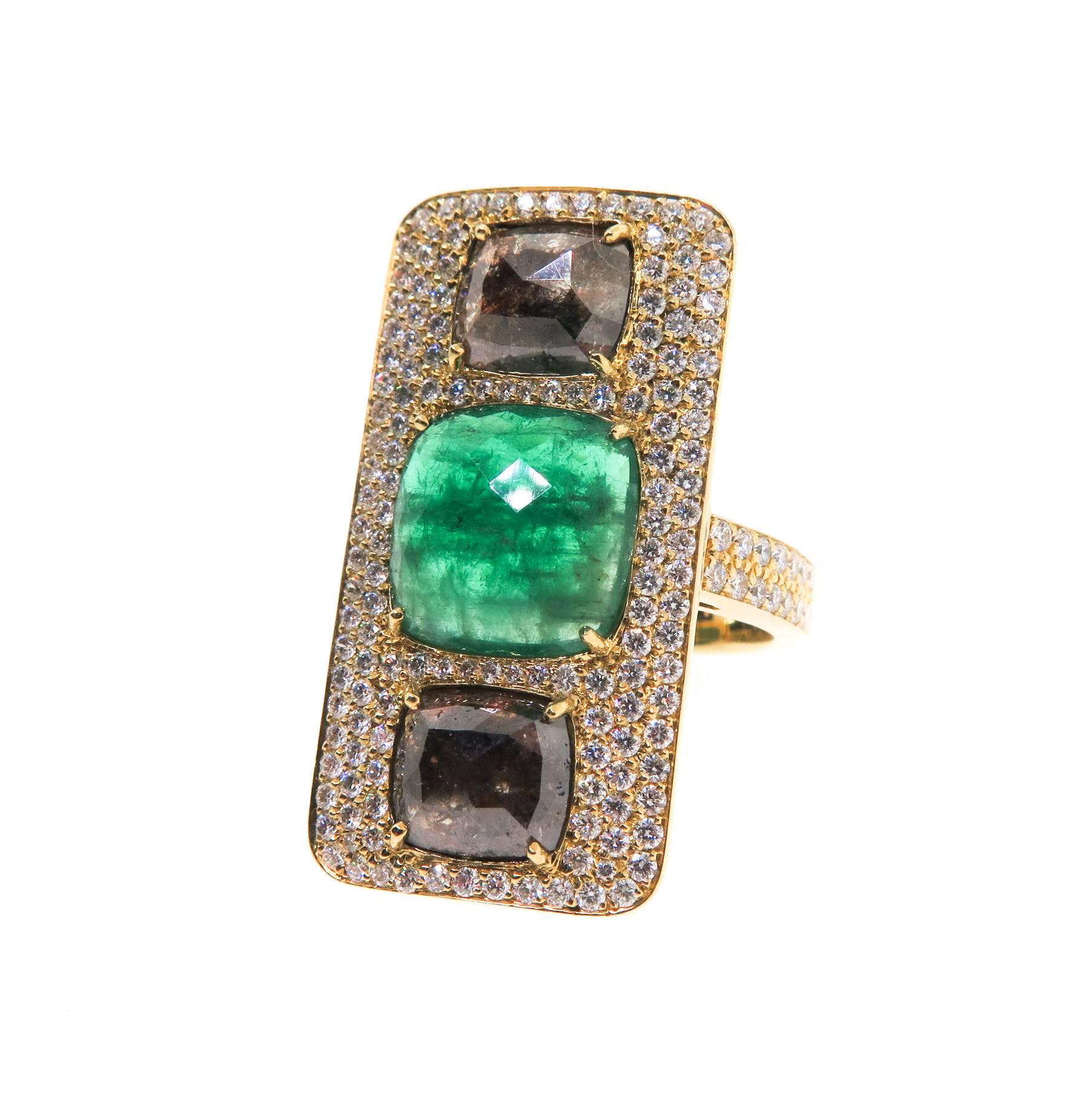 This incredible one of a kind ring is set with a vibrant green emerald in the center and natural colored diamonds at each end, framed by 1.48 carats of white diamond pave, set in 18K yellow gold. Finger size 7.5
The emerald is a medium dark green