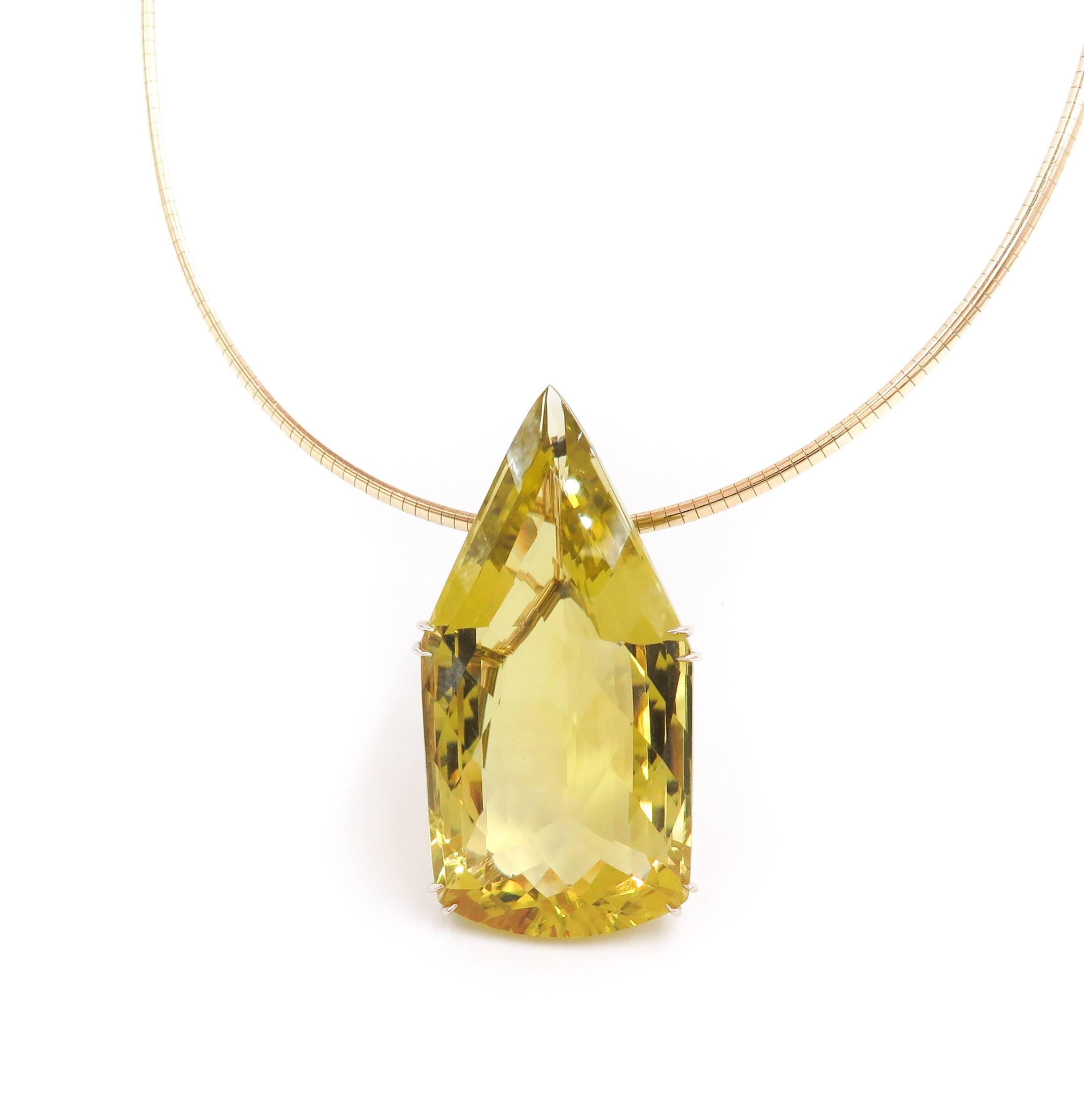 One of a Kind Pendant handcrafted in 14k yellow gold with a 200 carat faceted lemon quartz, suspended by an 18 inch long Omega necklace to showcase the beauty and brilliance of the Lemon Quartz.
The lemon quartz is 2.5 inches in length by 1.1 inches