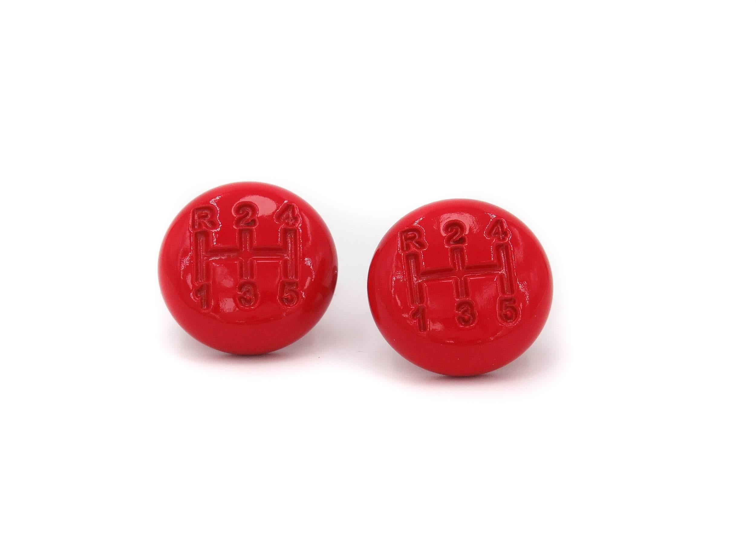 These Shift Knob cufflinks in red lacquered stainless steel are a discreet nod to the world of car racing. Their glossy red color and finely curved proportions make them a stylish and vibrant addition to shirt cuffs, with the gear-stick design
