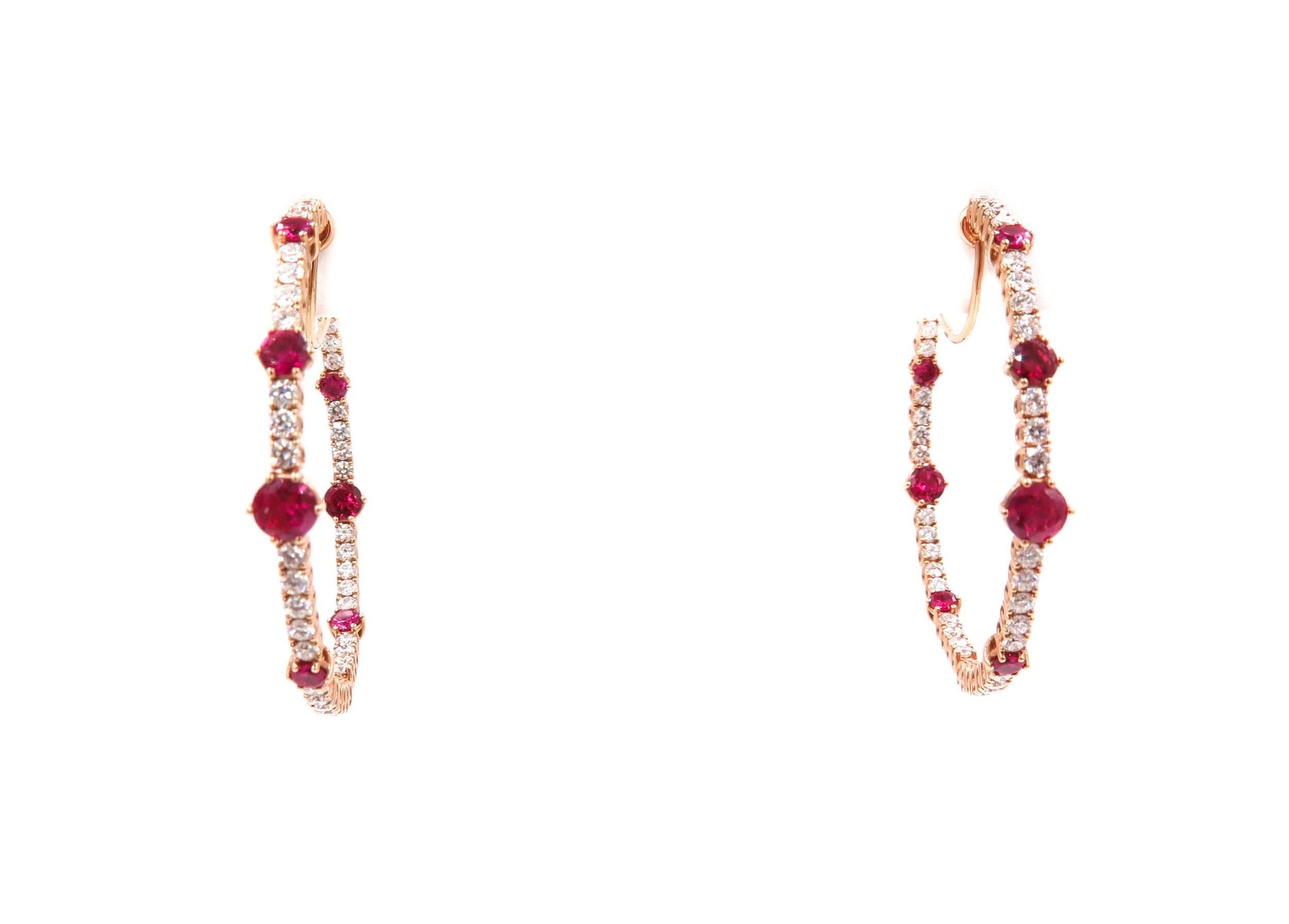This gorgeous Diamond and Ruby Hoop Earrings by Chopard, captures the essence of what a woman wants in her jewelry box! 
Breathtakingly featuring round brilliant diamonds with Ruby accents.  All 78 diamonds have a combined total weight of 1.69