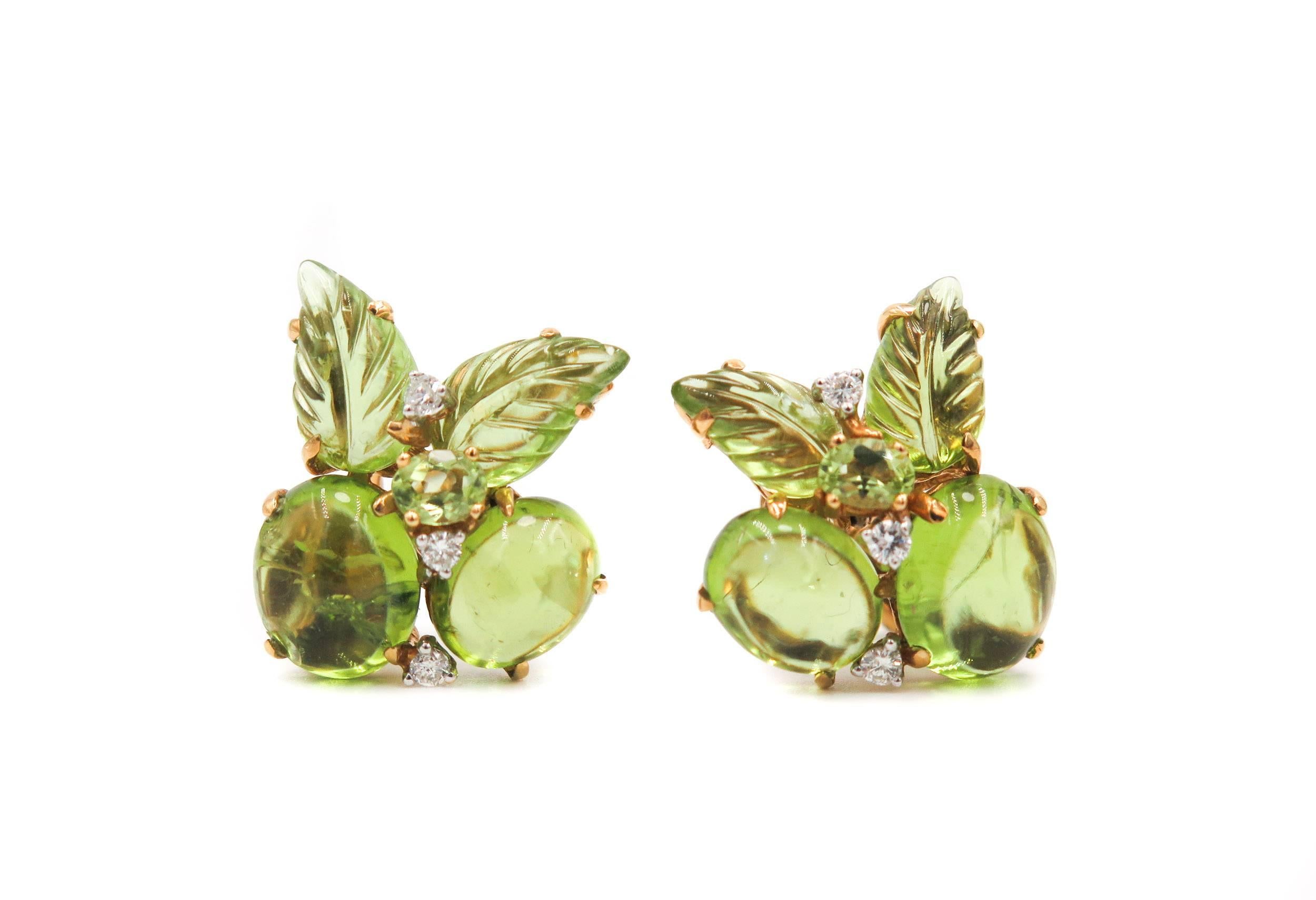 Beautiful peridot bubble cluster earrings with carved peridot leaves and diamonds set in 18k yellow gold. With hinged post so can be worn as either pierced or non. Stamped 750.


