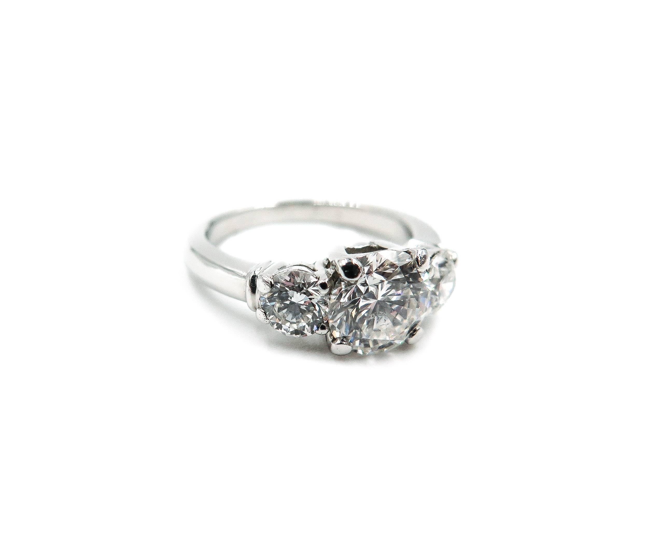 A design for a classic ring no matter the girl or the time period. 
The three-stone setting is a favorite amongst the masses and this ring is no exception. 
This estate piece holds a center diamond that is 1.60 carats and has a color of G and the