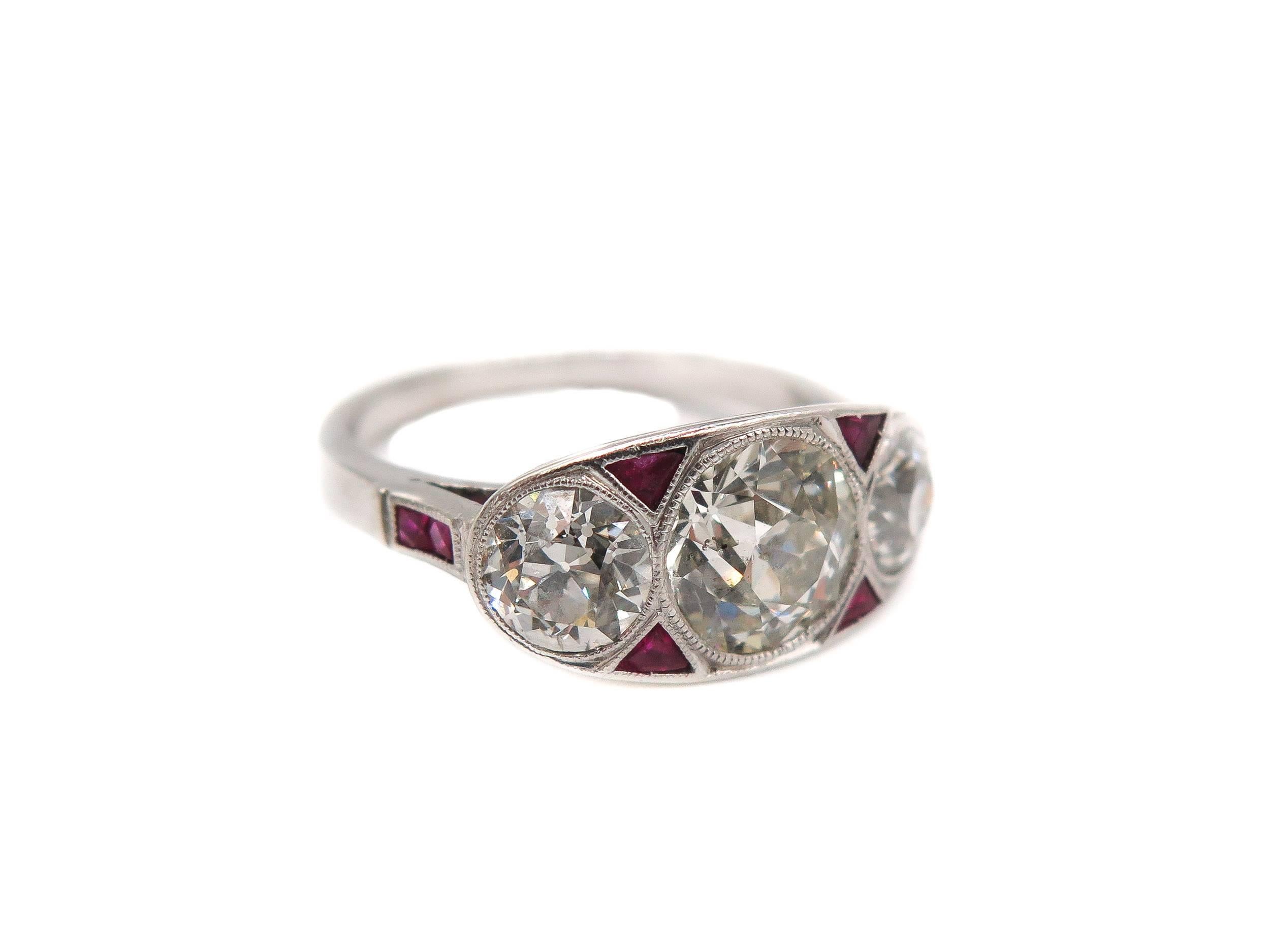 This gorgeous art deco platinum 3 stone ring is unlike anything you have seen before!
The diamonds are old european cut, G-H in color and SI1 in clarity, the center diamond weights approximately 1.75 carats and the side diamonds have a 1.20 carat