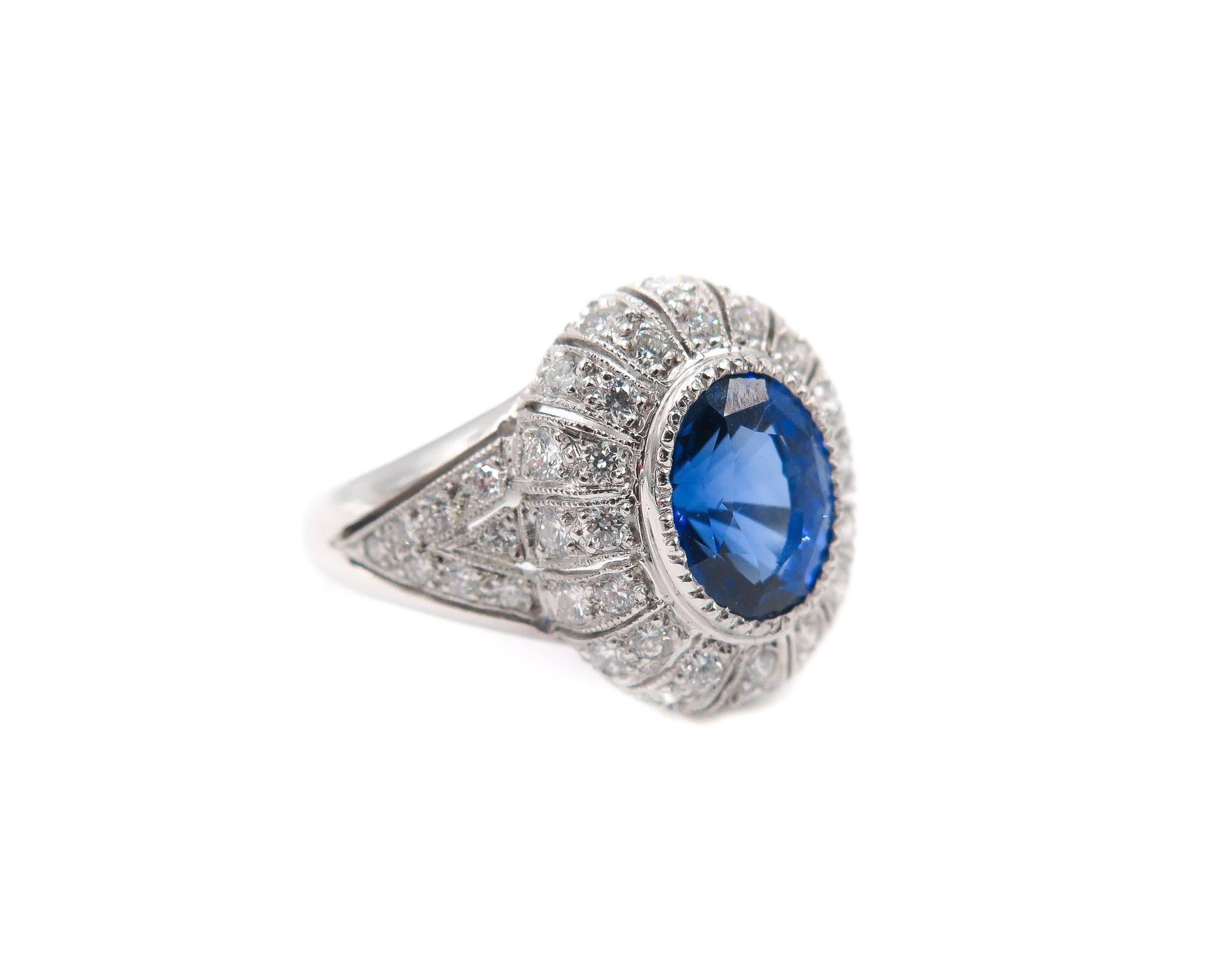 A stunning platinum cocktail ring featuring a 3.26 carat oval shaped blue sapphire set in an amazing vintage style, handcrafted, setting encrusted with 1.12 carats of round brilliant-cut diamonds. 
The ring is currently a size 7 with room to size up
