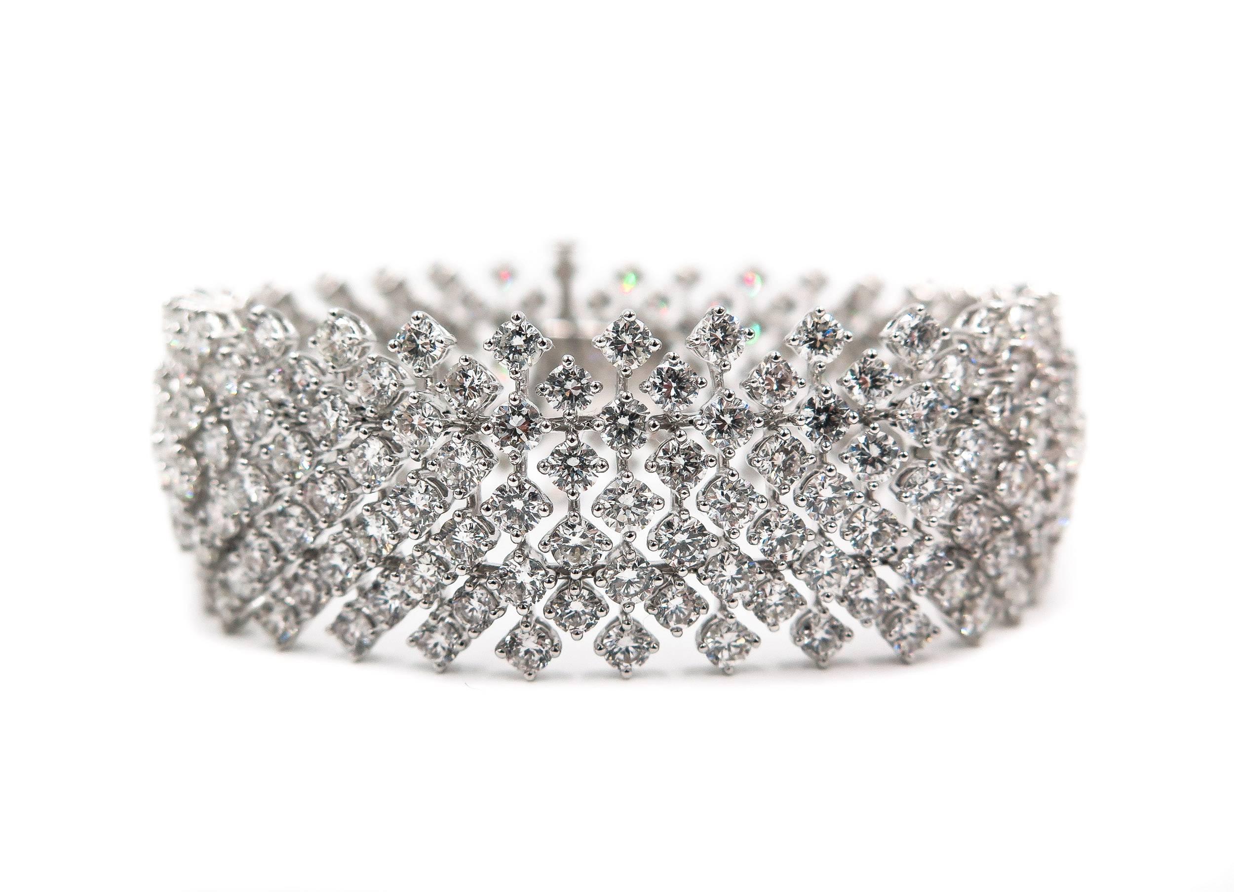 This Magnificent Bracelet features an intricate pattern of 9 rows of round brilliant cut Diamonds crafted in 18k White Gold.  
The soft and flexible design of the diamond bracelet drapes on the wrist with fluidity. 
The total diamond weight is 25.80