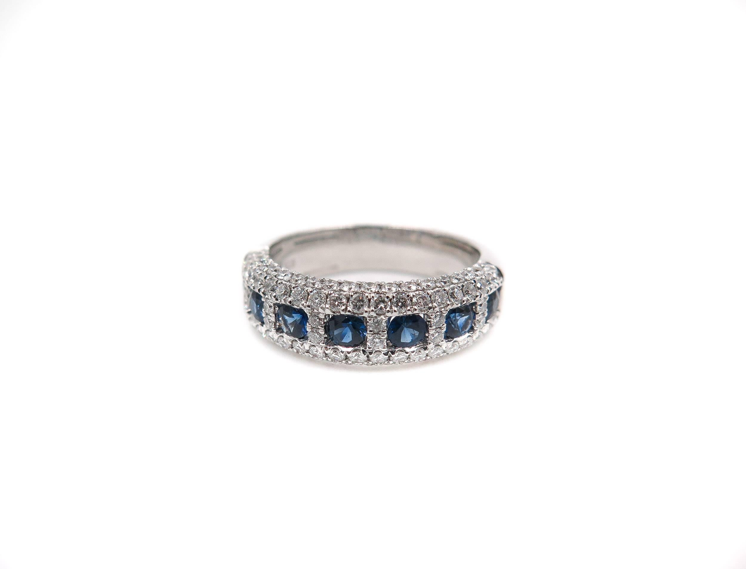The gorgeous blue color is mesmerizing in this sapphire and diamond band. 
This classic design brings you 7 princess cut blue sapphires weighing approximately 0.75 carats and accentuated by 0.75 carats of white round diamonds. 
Handcrafted in 18K