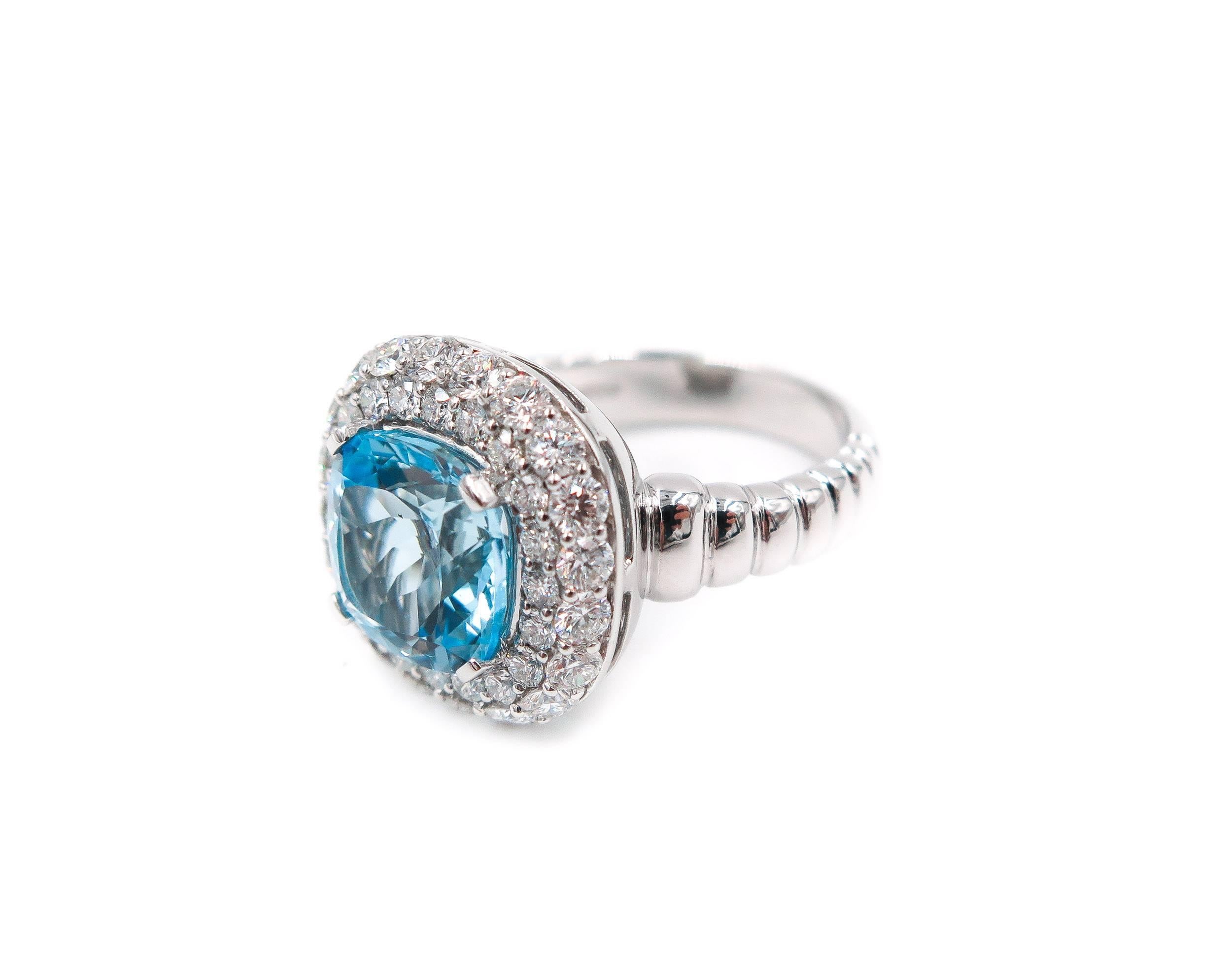 Cushion Cut Blue Topaz at its center, this ring is surrounded by 1.62 carats of Round Brilliant Cut White Diamonds (color F clarity VS), designed and crafted in Italy by Leo Pizzo in 18k White Gold to showcase the divine blue hue of the Topaz.
The