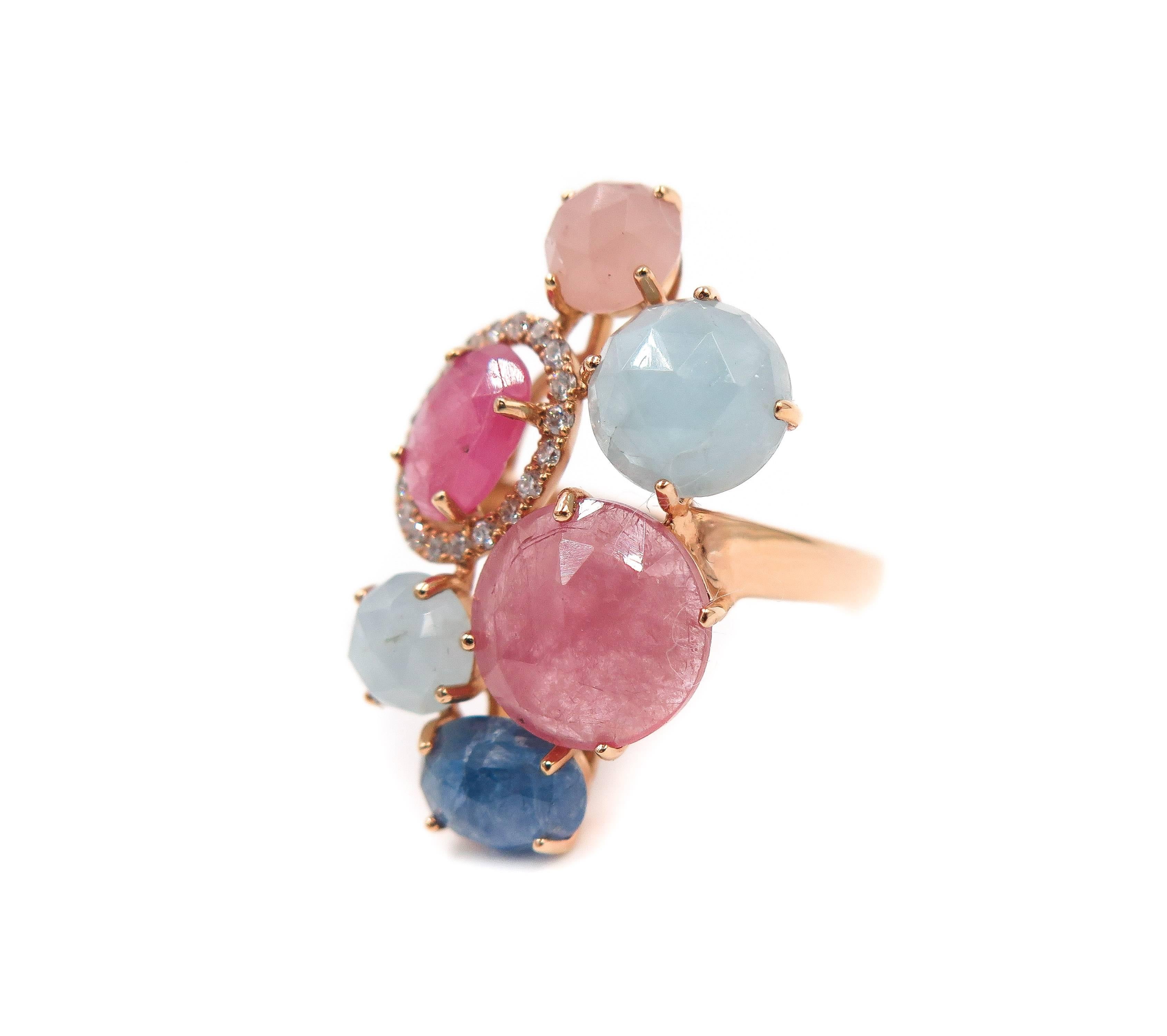 Handmade work is combined with passion and tradition of jewelry to create this ring from soft and simple shapes of multicolor faceted natural sapphires and adorned with white round diamonds set in 18K rose gold.
Definitely a ring you can enjoy and