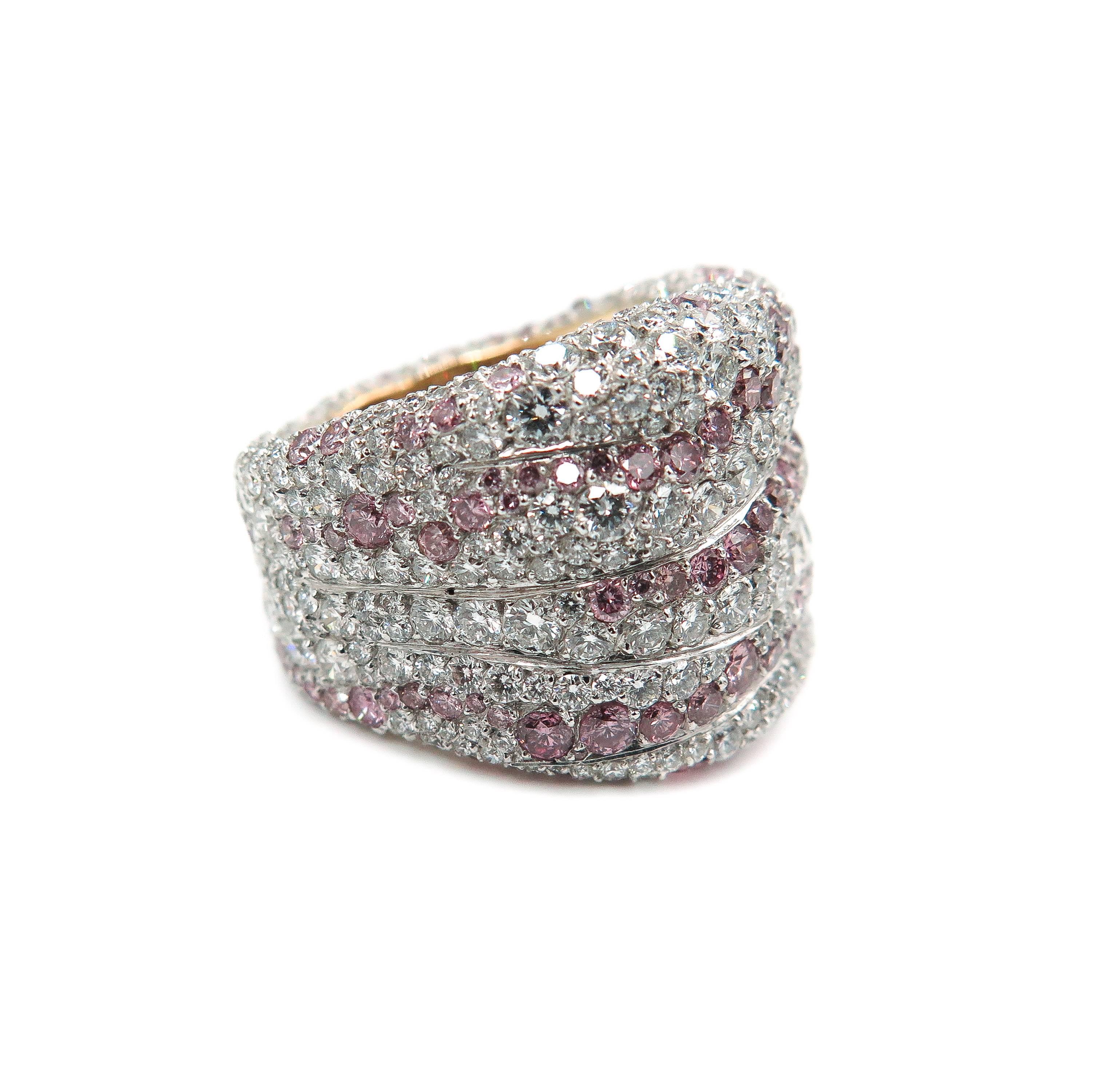 Explore the intellectual and artistic richness of Modern Fabergé in this bold and daring  design and craftsmanship.
 This ring is infused with white and intense pink diamonds giving a fluid wavy  pattern of color unlike any other.
The total white