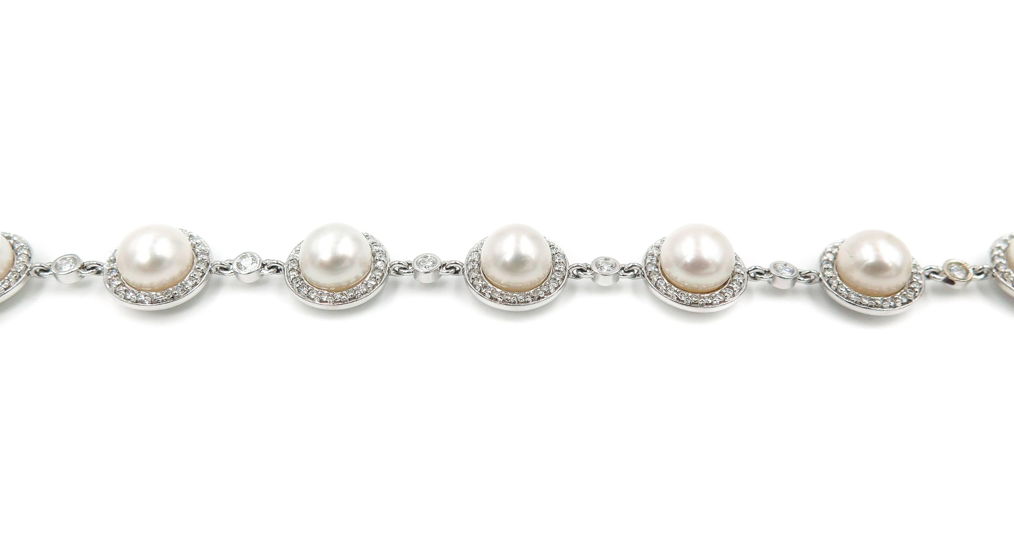 Pearls has always been part of a woman's staple jewelry collection.
This pearl bracelet features 10 beautiful pearls of 7-7.5mm in diameter perfectly framed by a halo of white diamonds set in 14k white gold with a hidden box clasp.
Measures 7 inches