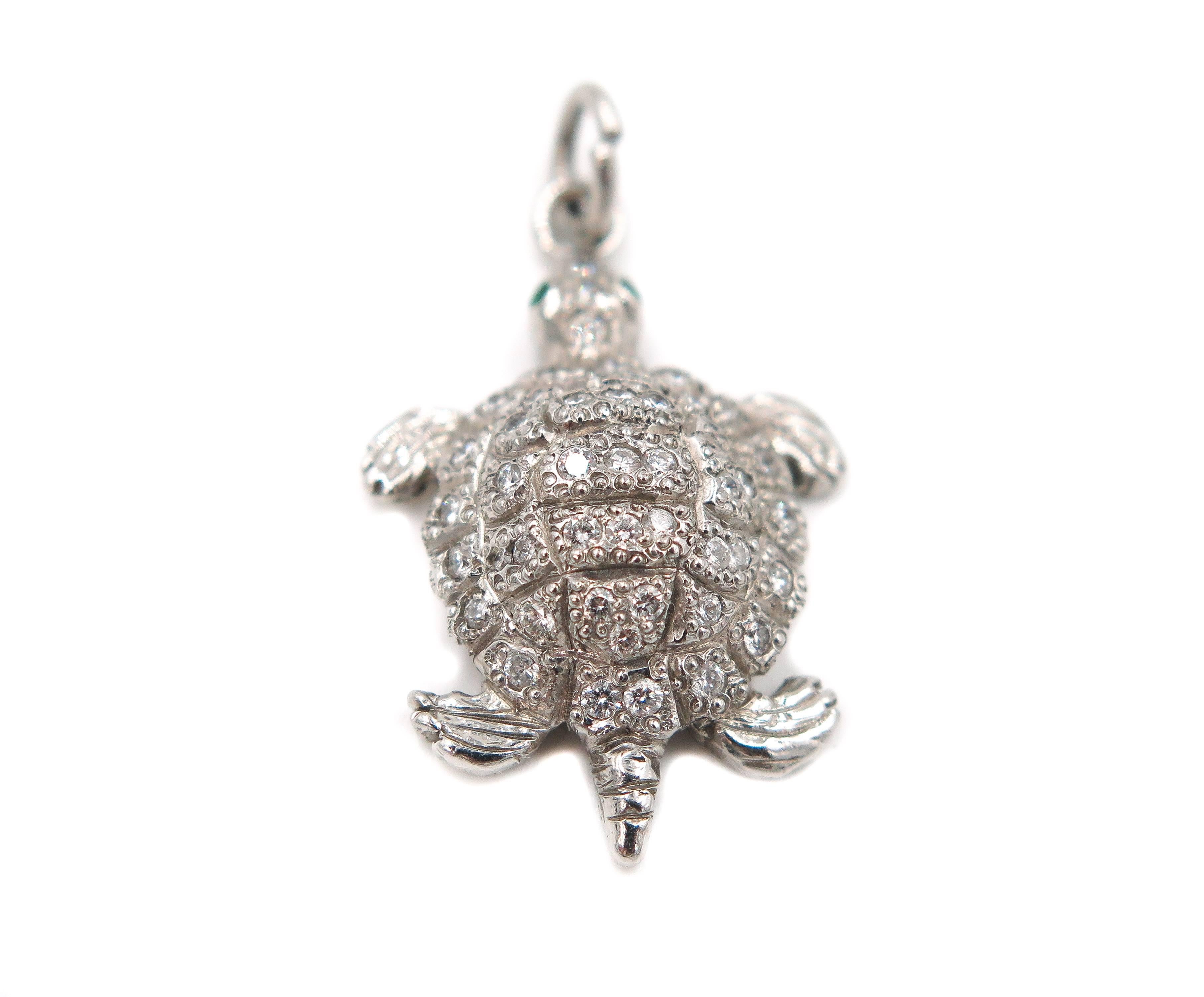 What a unique addition to your charm bracelet, this turtle charm meticulously handmade in platinum with .50 carats total weight of round brilliant cut diamonds is capped off with a pair of round cut emeralds for eyes.
Also makes a great pendant. 