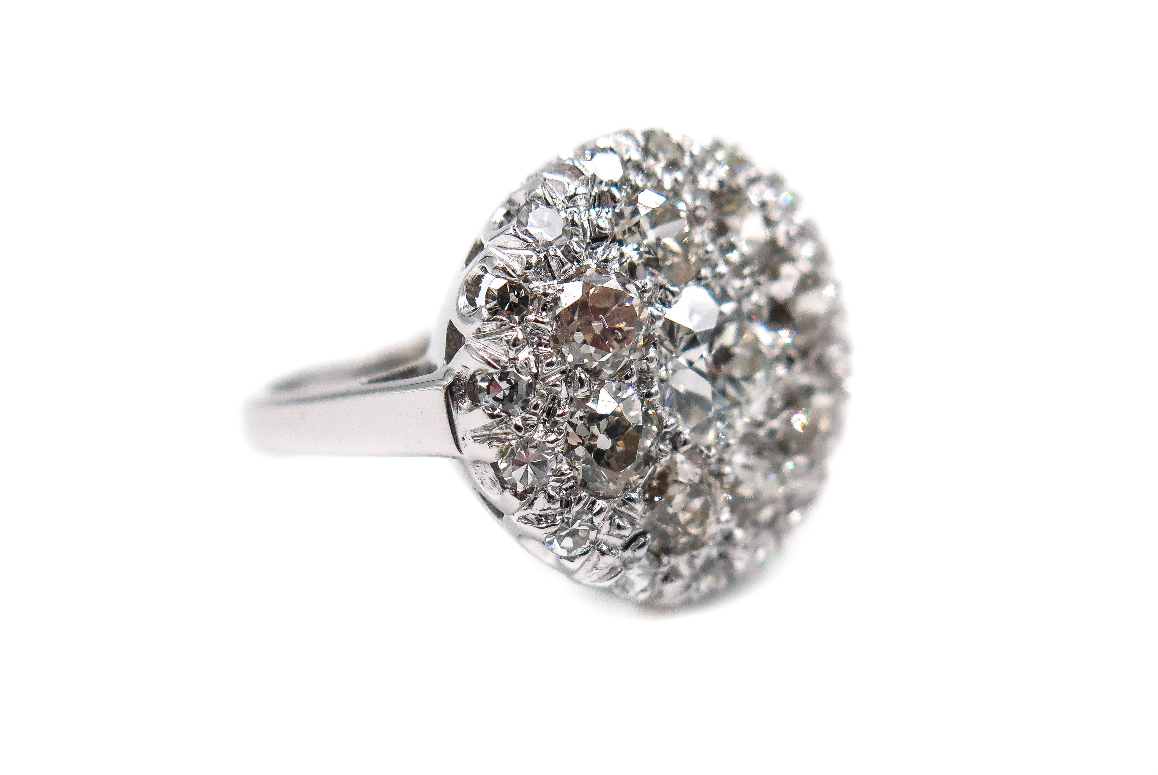 This gorgeous estate diamond ring makes a great complement to other pieces of jewelry from your collection or can be simply worn as an elegant cocktail ring.
The ring is comprised of a cluster of 1 carat total weight, H/I color diamonds, handcrafted