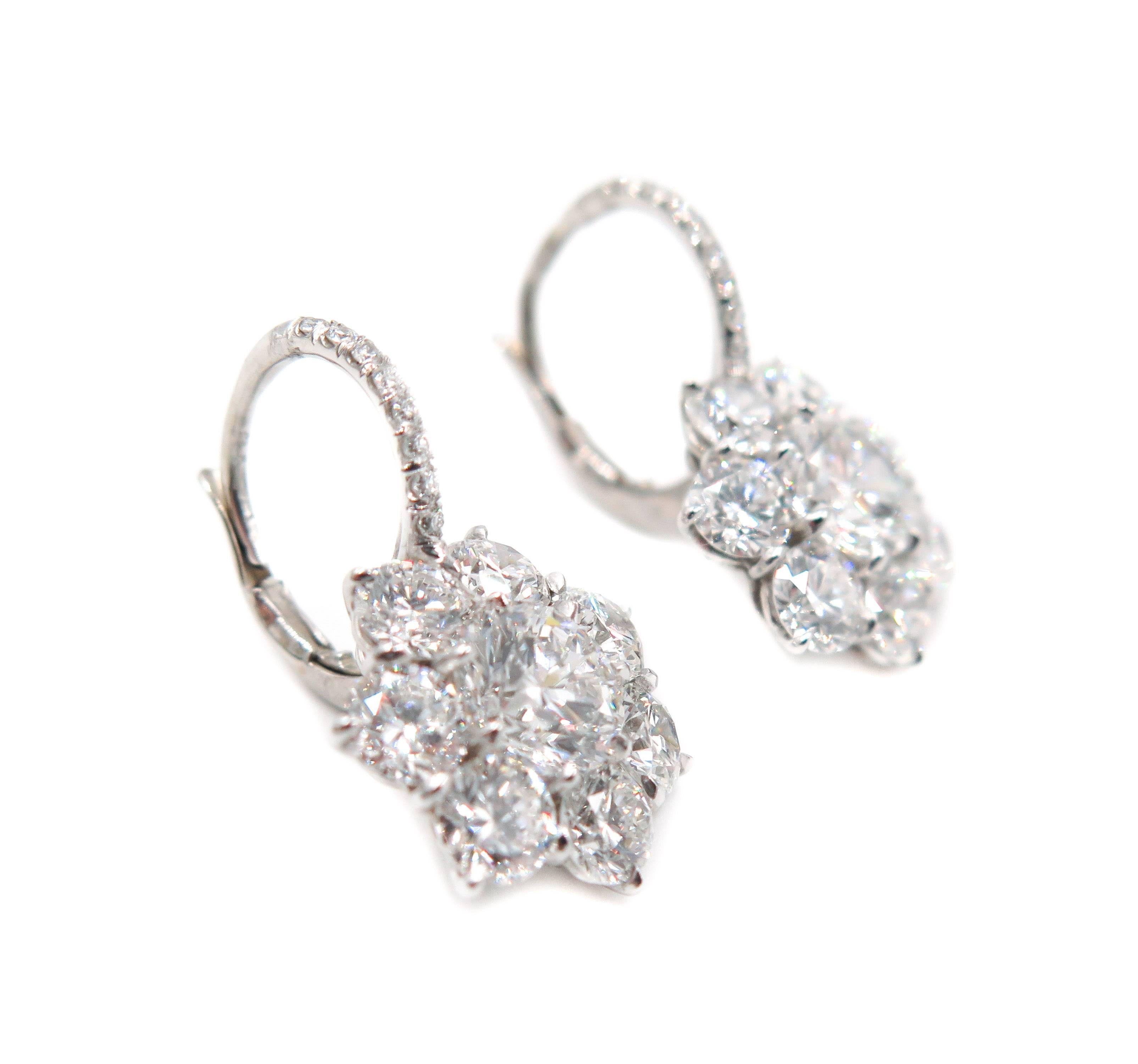 A little more inspired... yet very wearable. 
A gorgeous diamond cluster earrings arranged in a floral shape. 
Handcrafted in Platinum with a total of 5.45 carats of diamonds.
Both center diamonds weight 1.00 carat each (GIA certified), yet appears