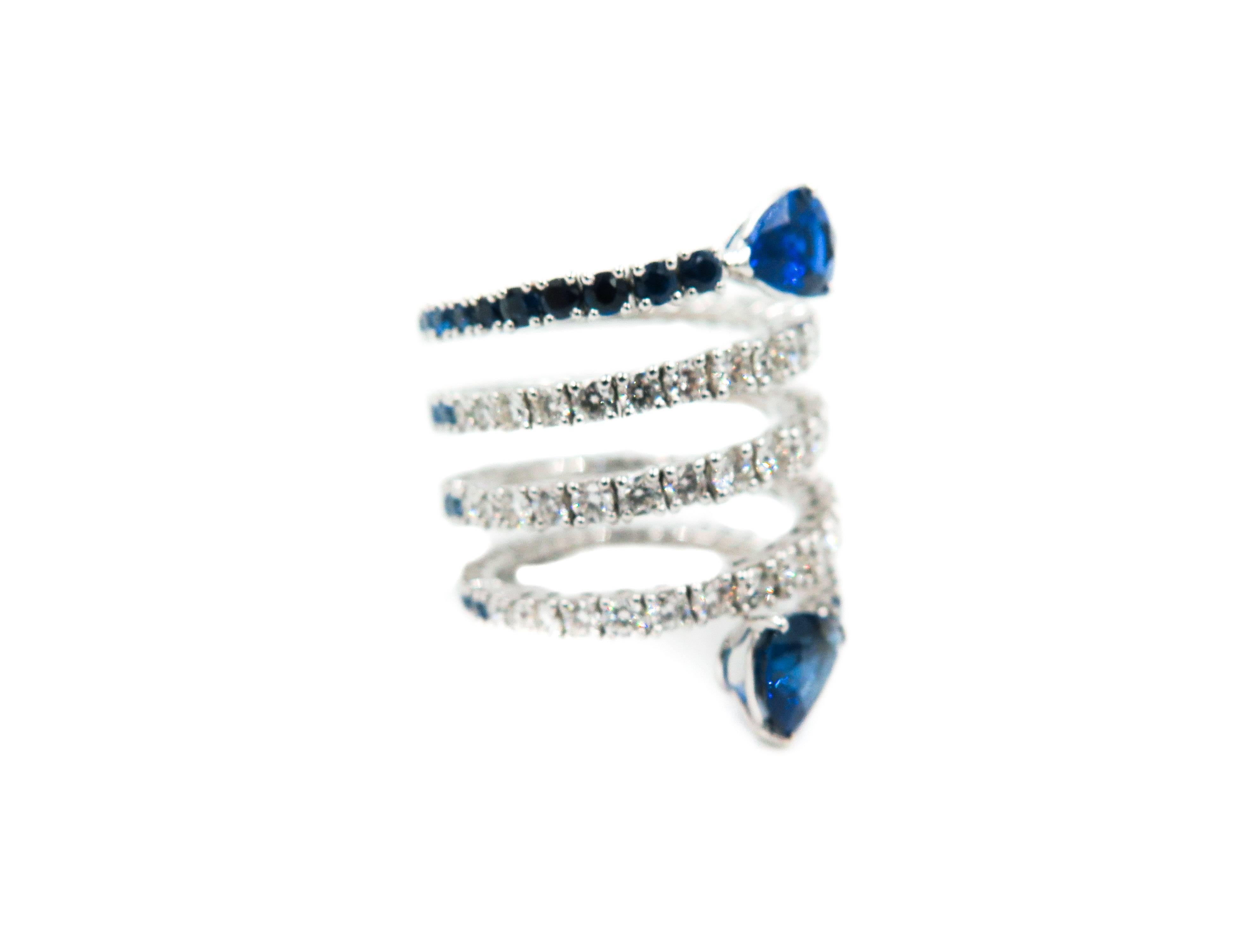 Each gemstone tells a different story and the combination develops into new tales . 
This bi-color spiral ring is different from any other, it is created with the most beautiful color combination: sapphires and diamonds.
Half of the spiral is a line