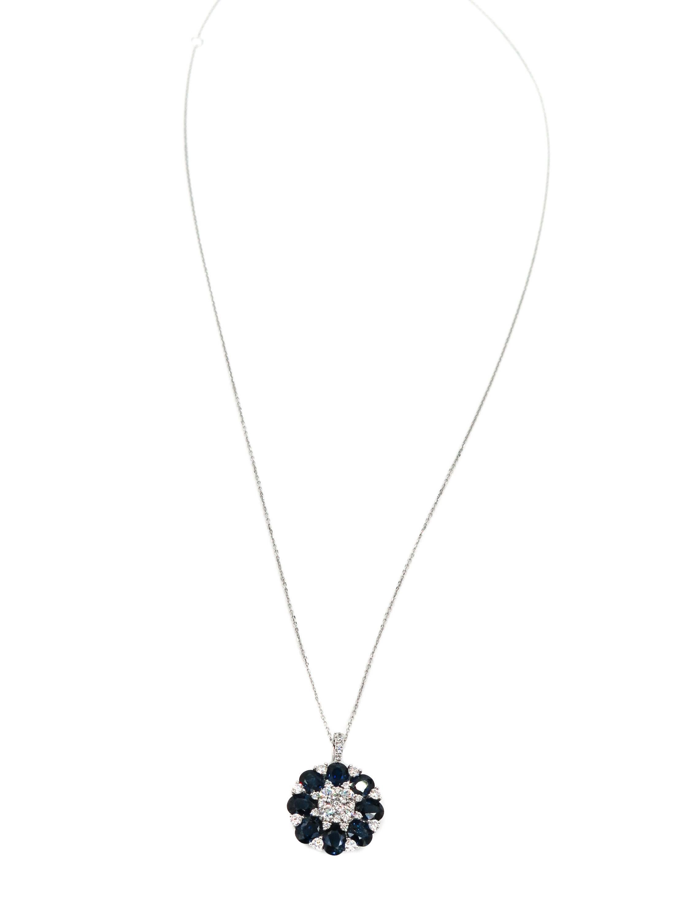 When words are not enough... colors and shapes can speak for themselves. 
Eight oval cut blue sapphires, enriched by 31 round brilliant cut diamonds bloom into this beautiful pendant.  
Creatively crafted in 18 karat white gold, with 3.64 carats of