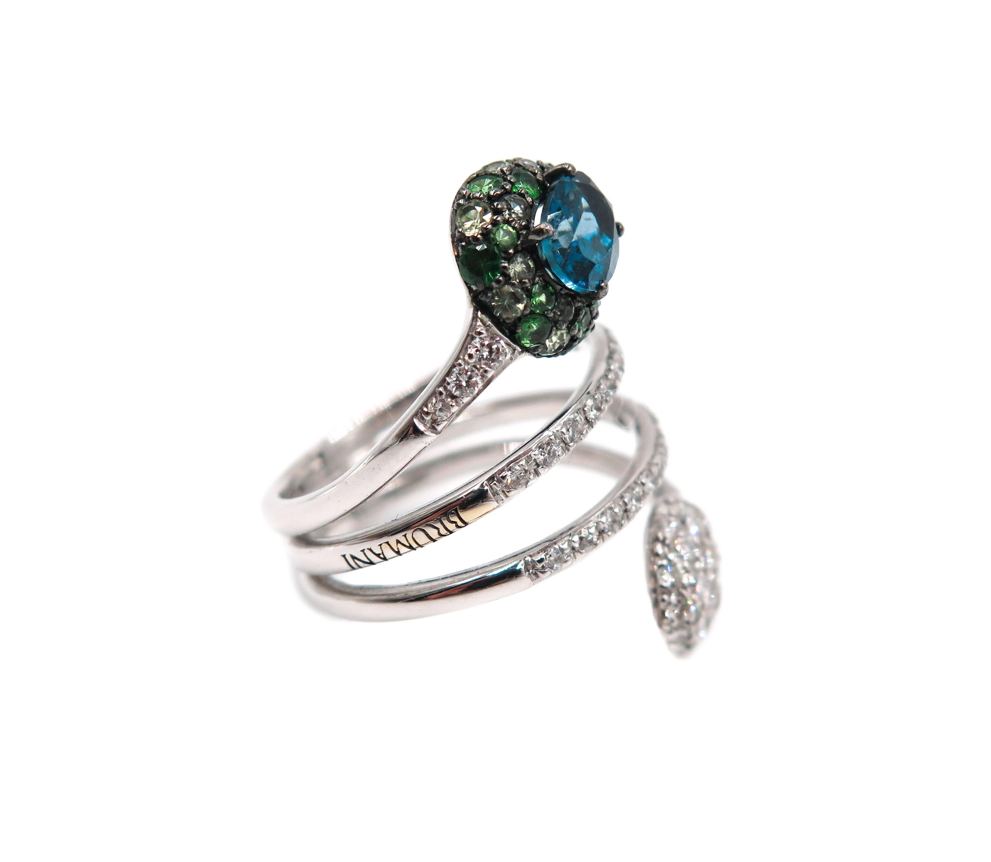 Playful and a different kind of fashion ring :)
Designed by Brumani and handcrafted in 18k white gold featuring an oval blue tourmaline and accented by a mix of pave green tourmaline and round diamonds.
Finger size: 7