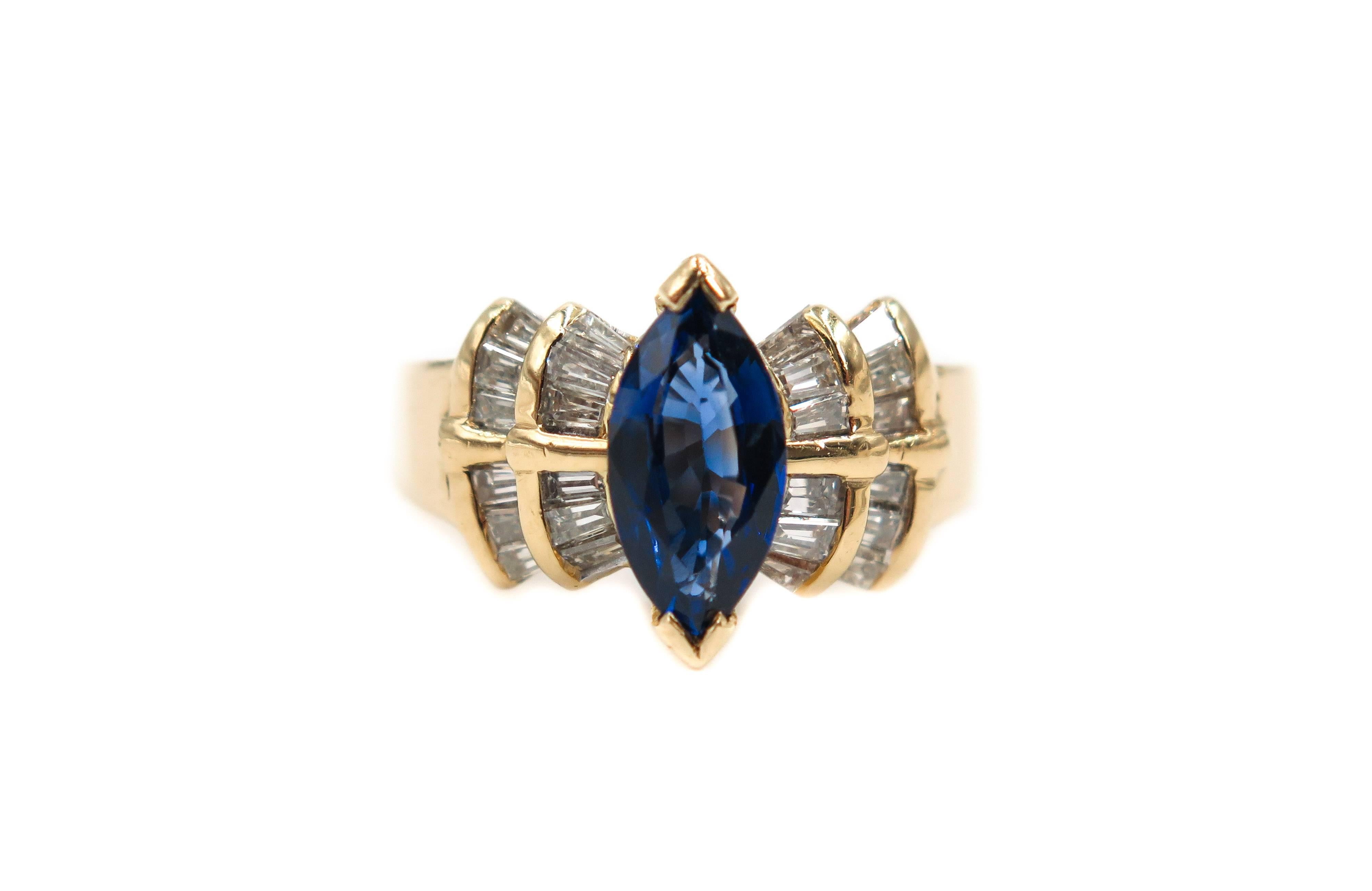 This Estate Ring is a classic design, centered is a 1 carat marquise cut blue sapphire. Accented on either side by layers of tapered diamond baguettes, weighing approximately 0.50 carats. Crafted in 18k yellow gold.
Ring finger size 7