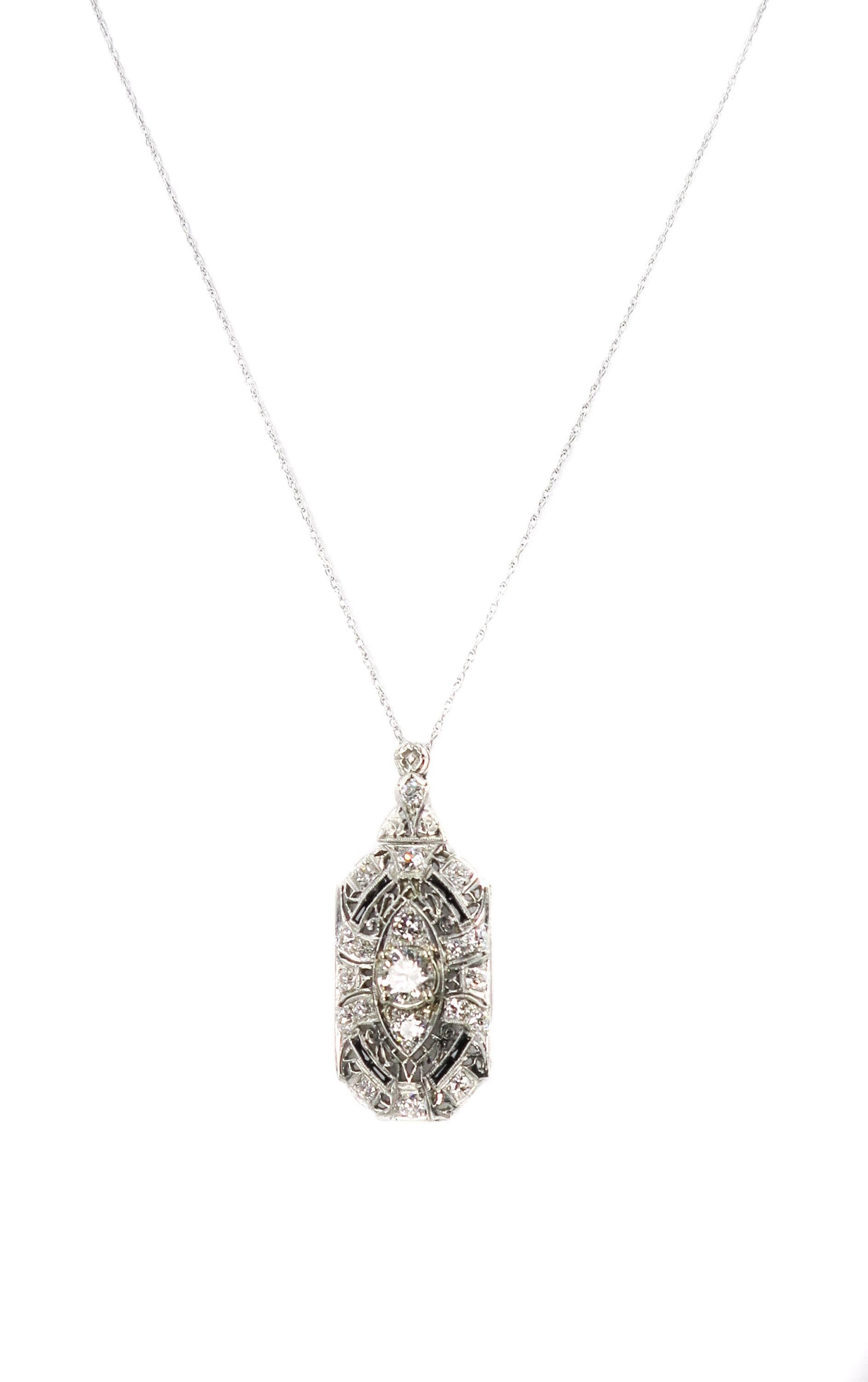 This gorgeous platinum brooch/pendant from the Art Deco era, is centered with a sparkling old mine cut diamond weighing approximately 1.00ct. and smaller old mine cut diamonds weighing approximately 1.25 carats total. The diamond are graded H-I