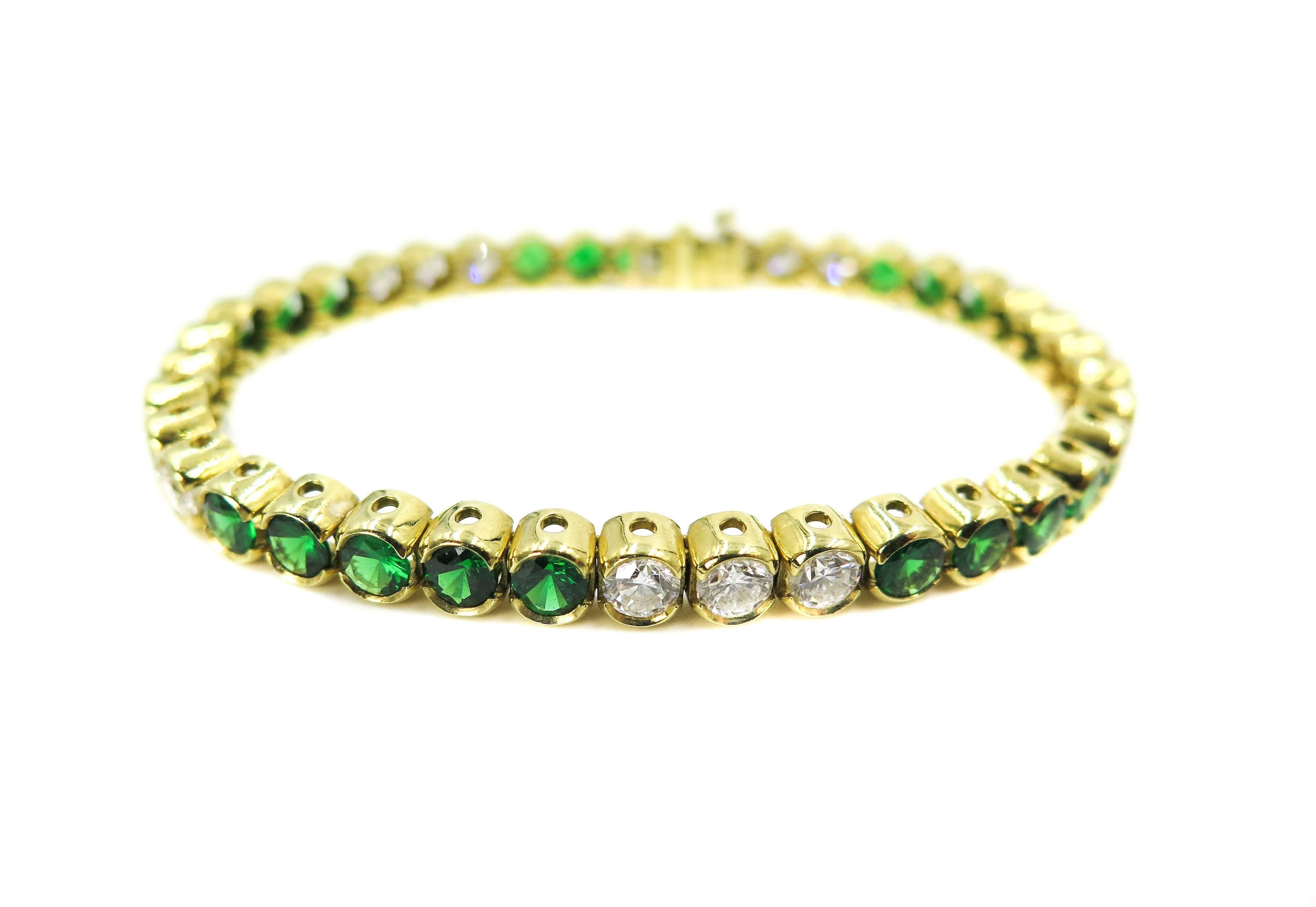 Round brilliant diamond and tsavorite line bracelet in 18k yellow gold. 
15 matching, near-colorless diamonds (G-H color) weighing 4.50 total carats, alternating with 24 round Tsavorite, weighing approximately 6.00 carats. 
Set in a classic, half