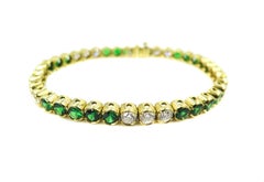 Bracciale tennis con tsavorite e diamanti in oro giallo