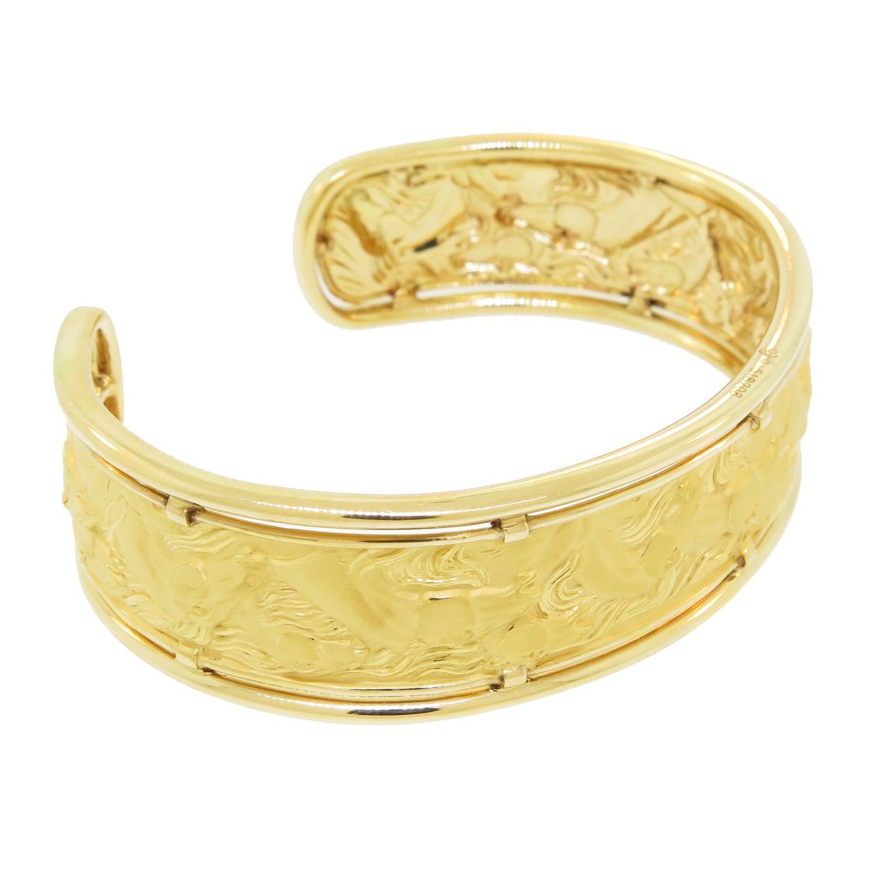 Stunning 18 karat yellow gold hand engraved horse cuff bracelet.  Carrera y Carrera's signature finish of their gold gives this bracelet a unique look!