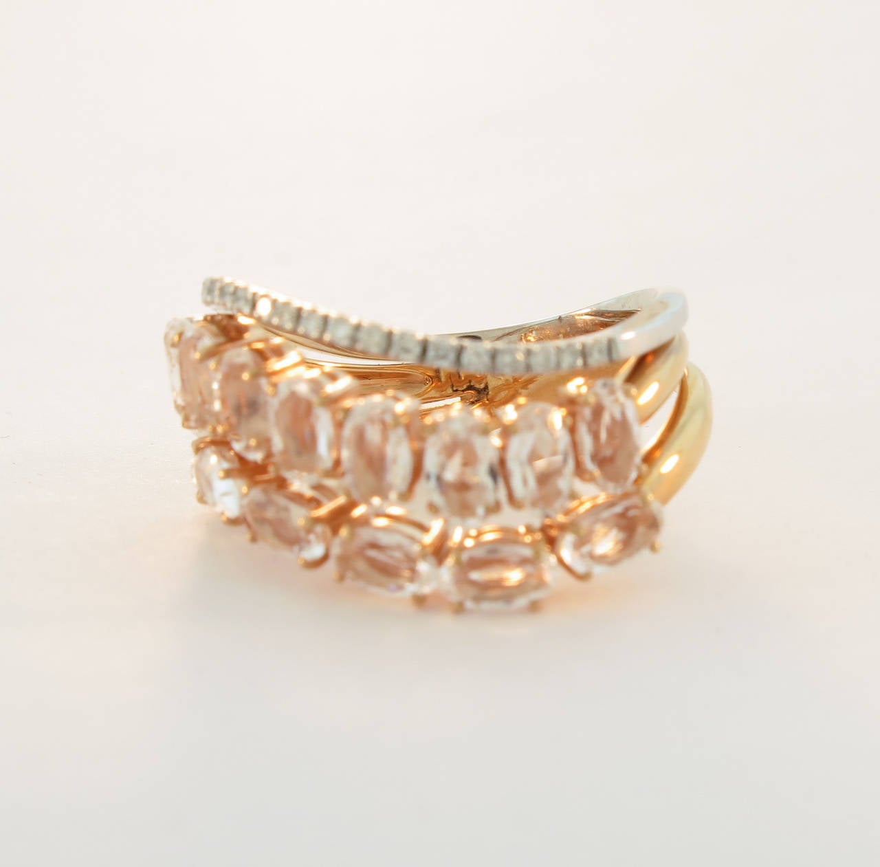 This 18K rose gold Ring features Diamonds and translucent oval rose Quartz, arranged in a beautiful soft wave design.