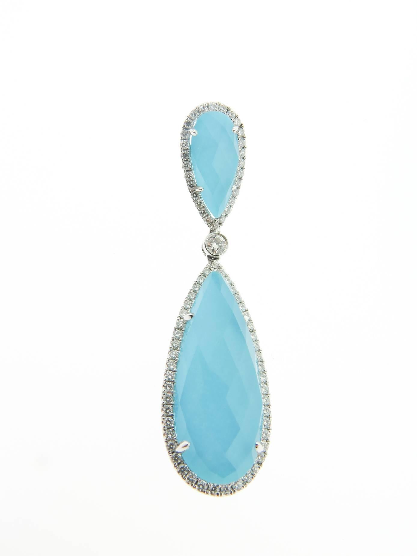 These amazing drop earrings have two pear-shaped turquoise doublets with white topaz and surrounded by dazzling prong-set diamonds in 18k white gold. 