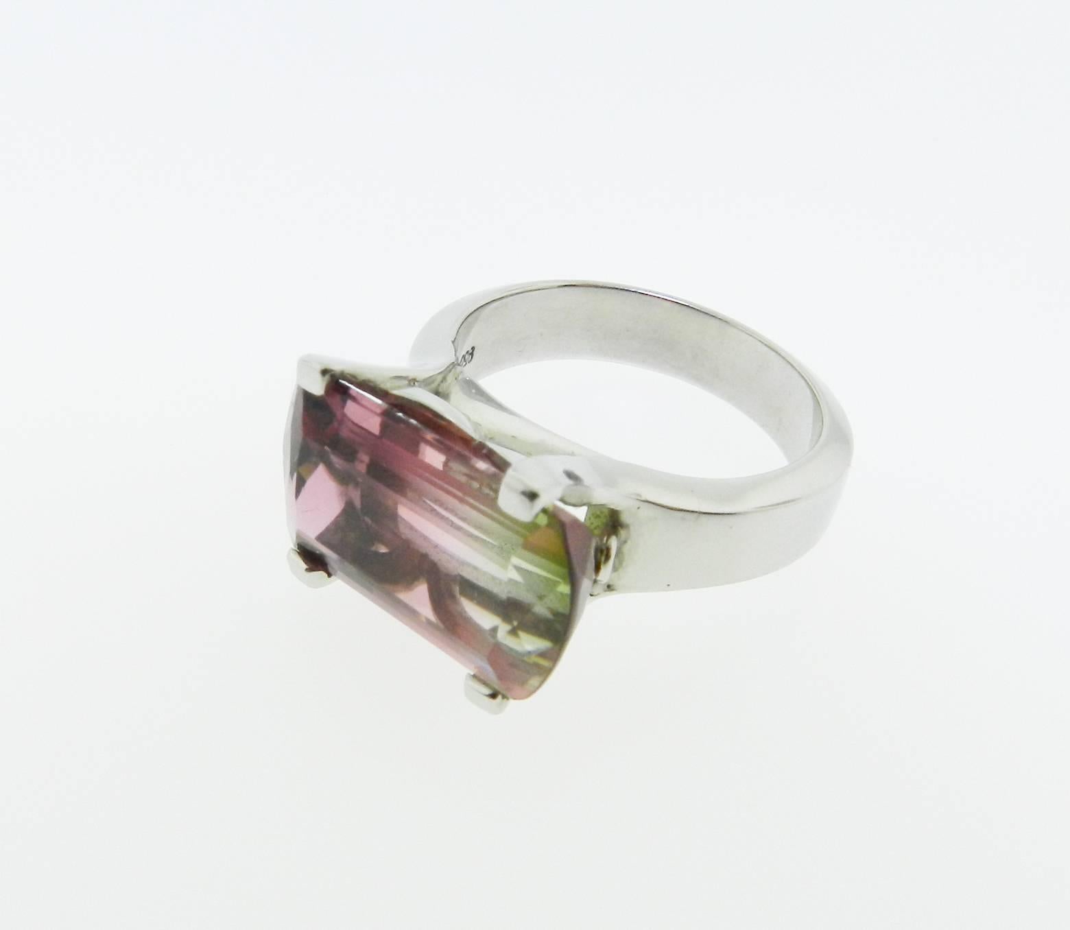 Stunning and unique elongated-shaped, faceted bi-color tourmaline ring. Handcrafted in platinum. 
Size 6