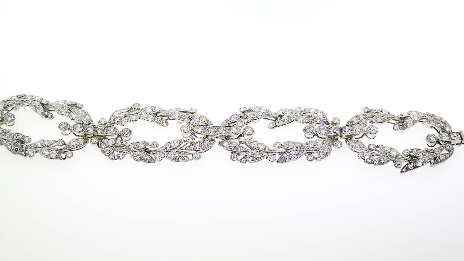 A magnificent bracelet by Cartier, designed with a broad leaf design centering  diamonds in oval shaped flowing towards a beautiful clasp accented with round diamonds; platinum, circa 1900s, 170 round diamonds, with a total weight 16 carats.