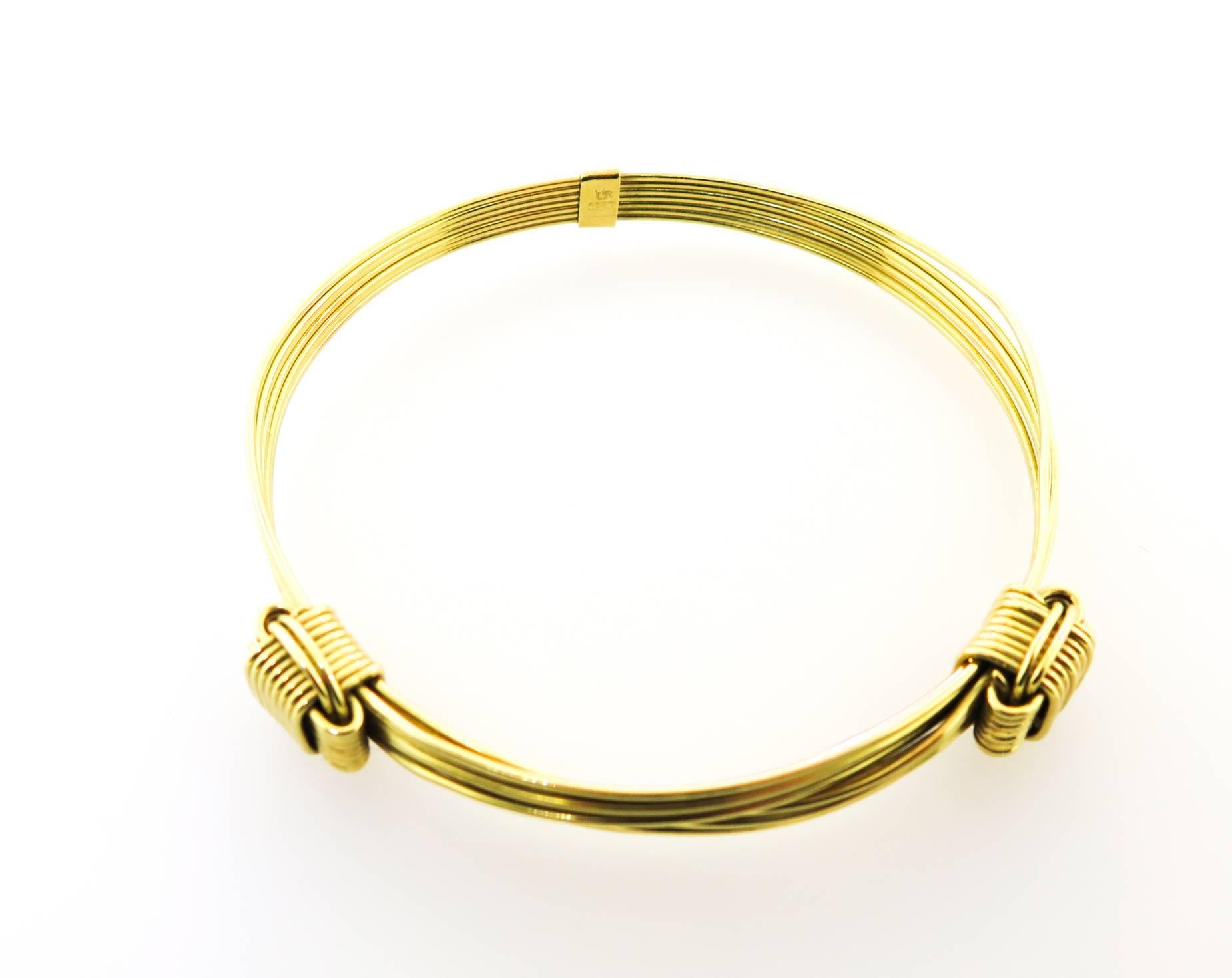 18k Solid yellow gold woven 7strands of rounded wire bracelet with 2 knots, designed to imitate the iconic 