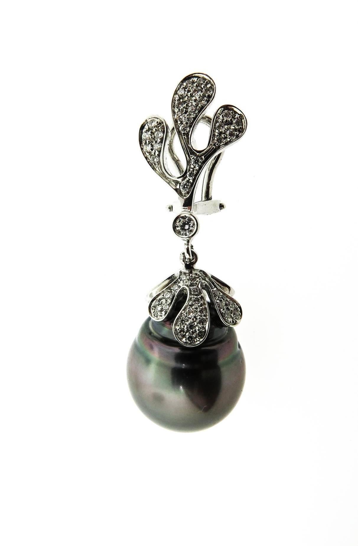 Absolutely stunning drop earrings featuring a pair of Black Tahitian Pearls set in a 18k white gold with sea leaf diamond designs.  Omega clips with post back closure.