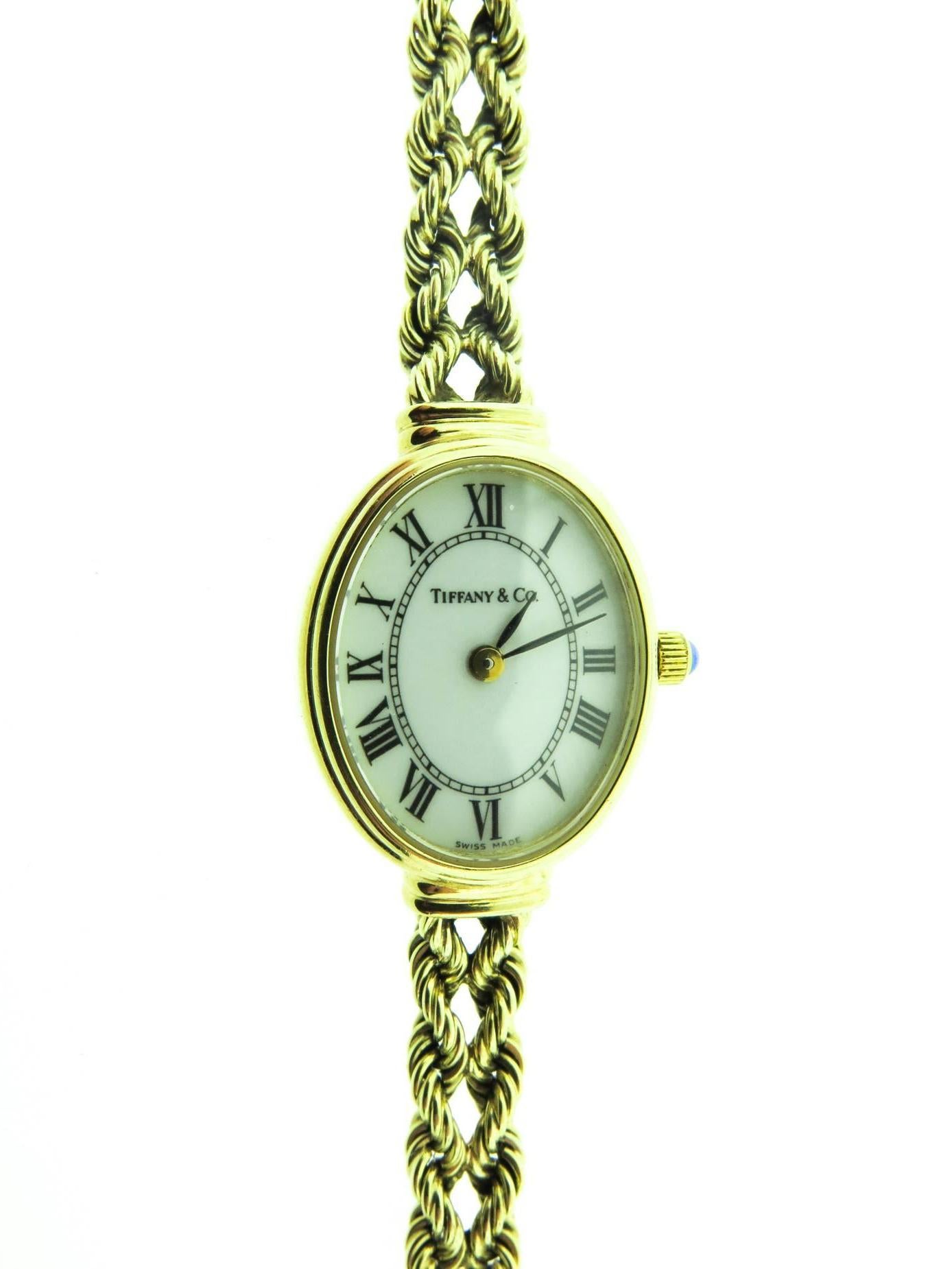 Tiffany & Co. Solid 14k solid yellow gold watch, in excellent running condition. 
Case Length x Width: 27.50mm x 24.75mm (with crown). Case Thickness: 4.70mm. White dial with Black Roman Numeral Hour Markers. Additional rope piece (part of