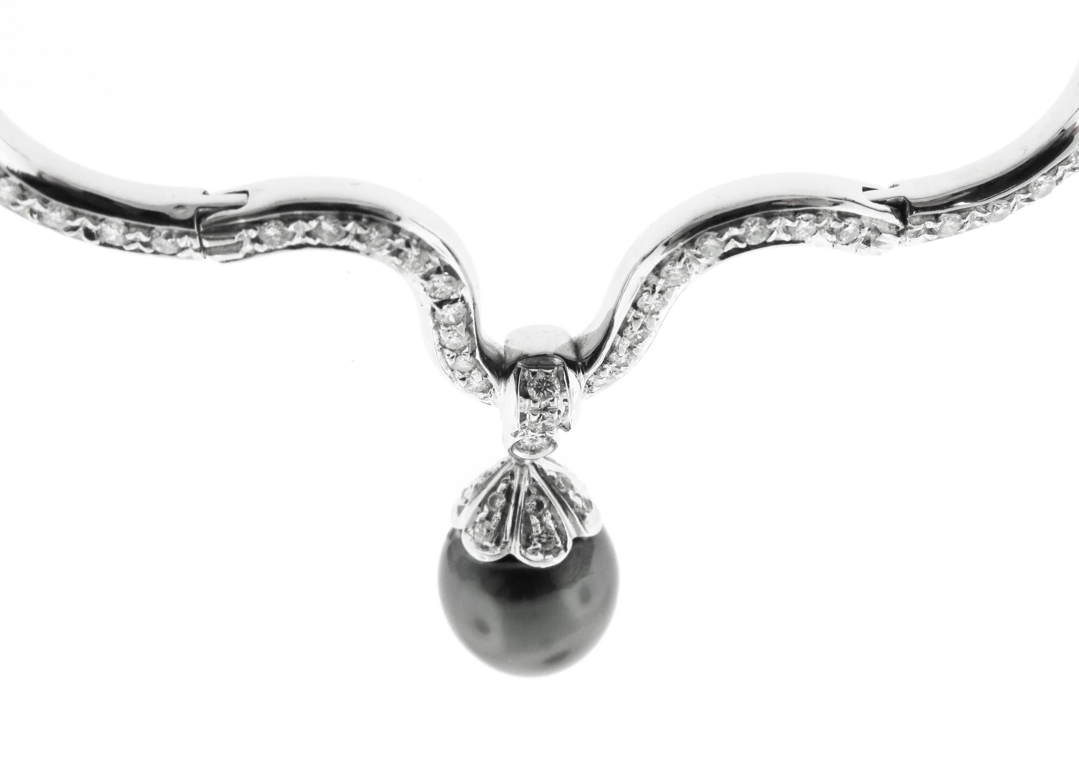 Majestic, memorable and tasteful, this fabulous 18K white gold necklace is a truly fascinating sight to behold, boasting a gorgeous Black Tahitian Pearl Drop which centers an Impressive wave of Diamonds glittering all the way up to the the half-way
