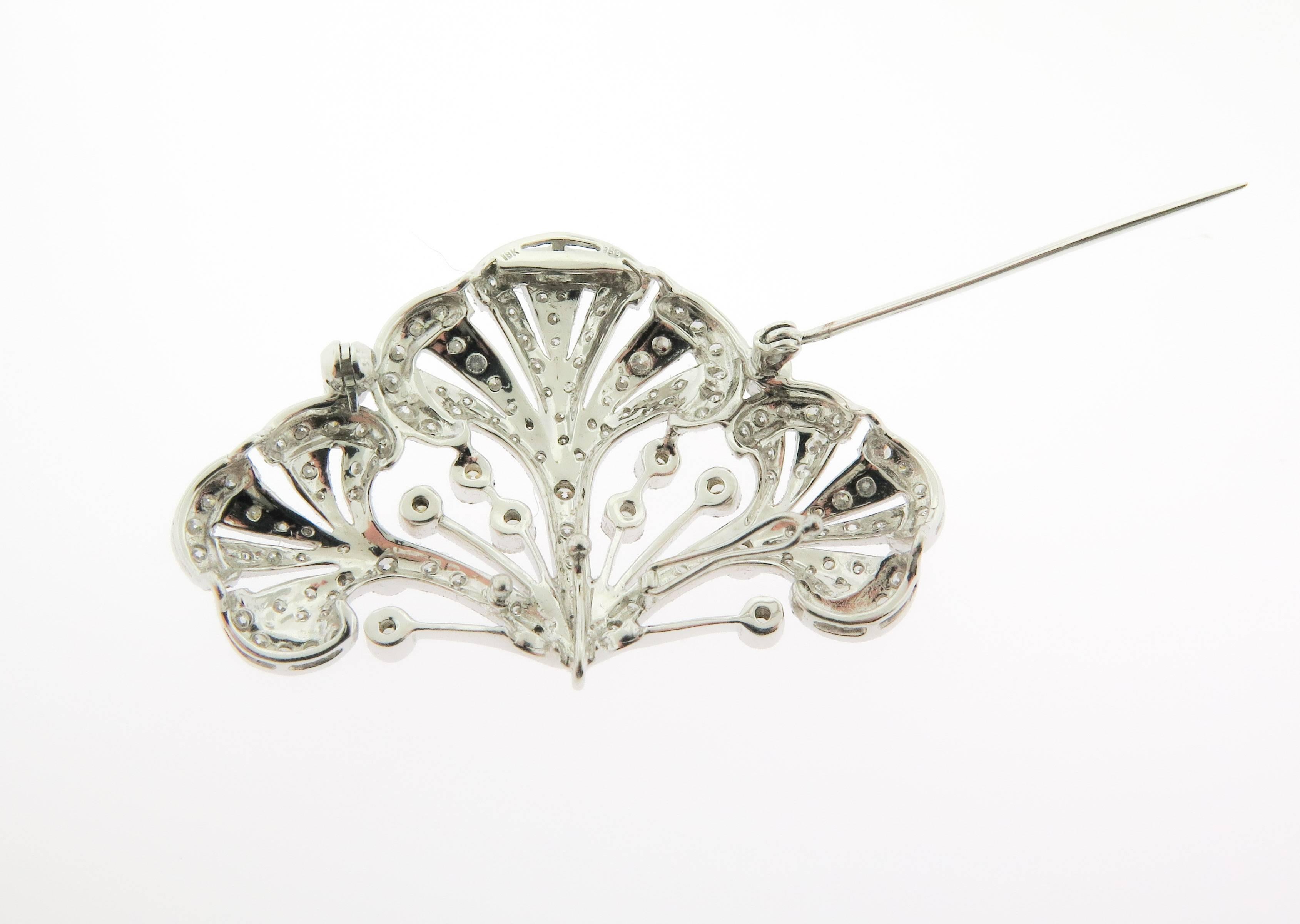  Crafted in 18 karat white gold and diamond brooch, circa 1930.  Open design set with round diamonds weighing approximately 2.64 carats, with retractable pendant hoop and detachable pin mechanism. The perfect accessory :) 